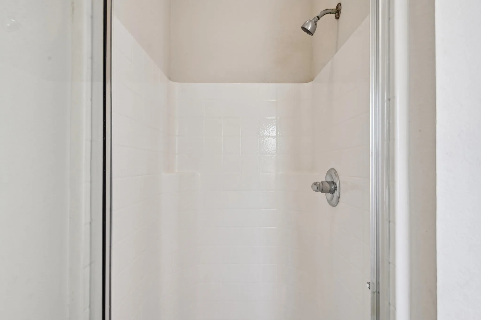 Interior details featuring a tile shower