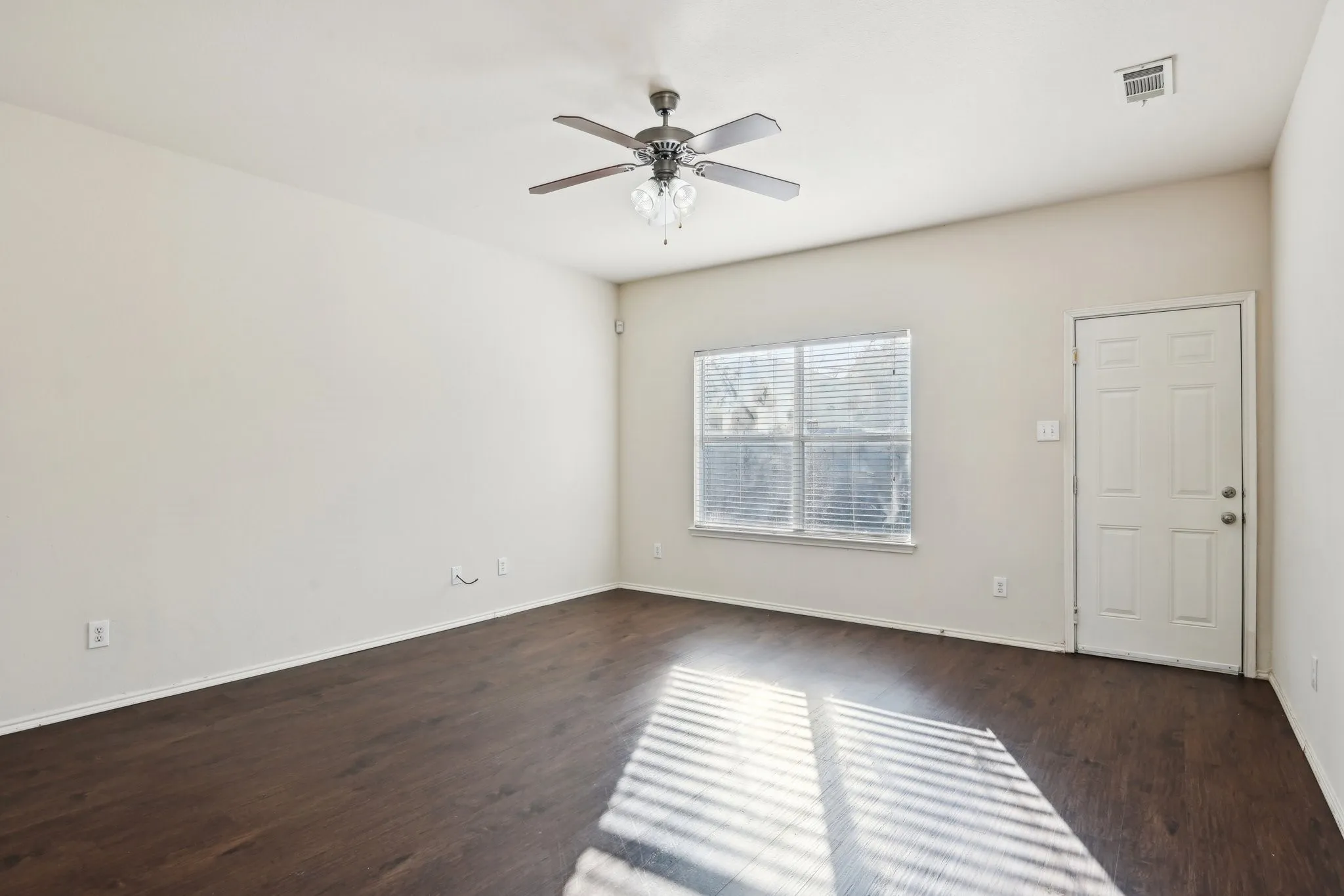 room featuring dark wood-type flooring and ceiling fan