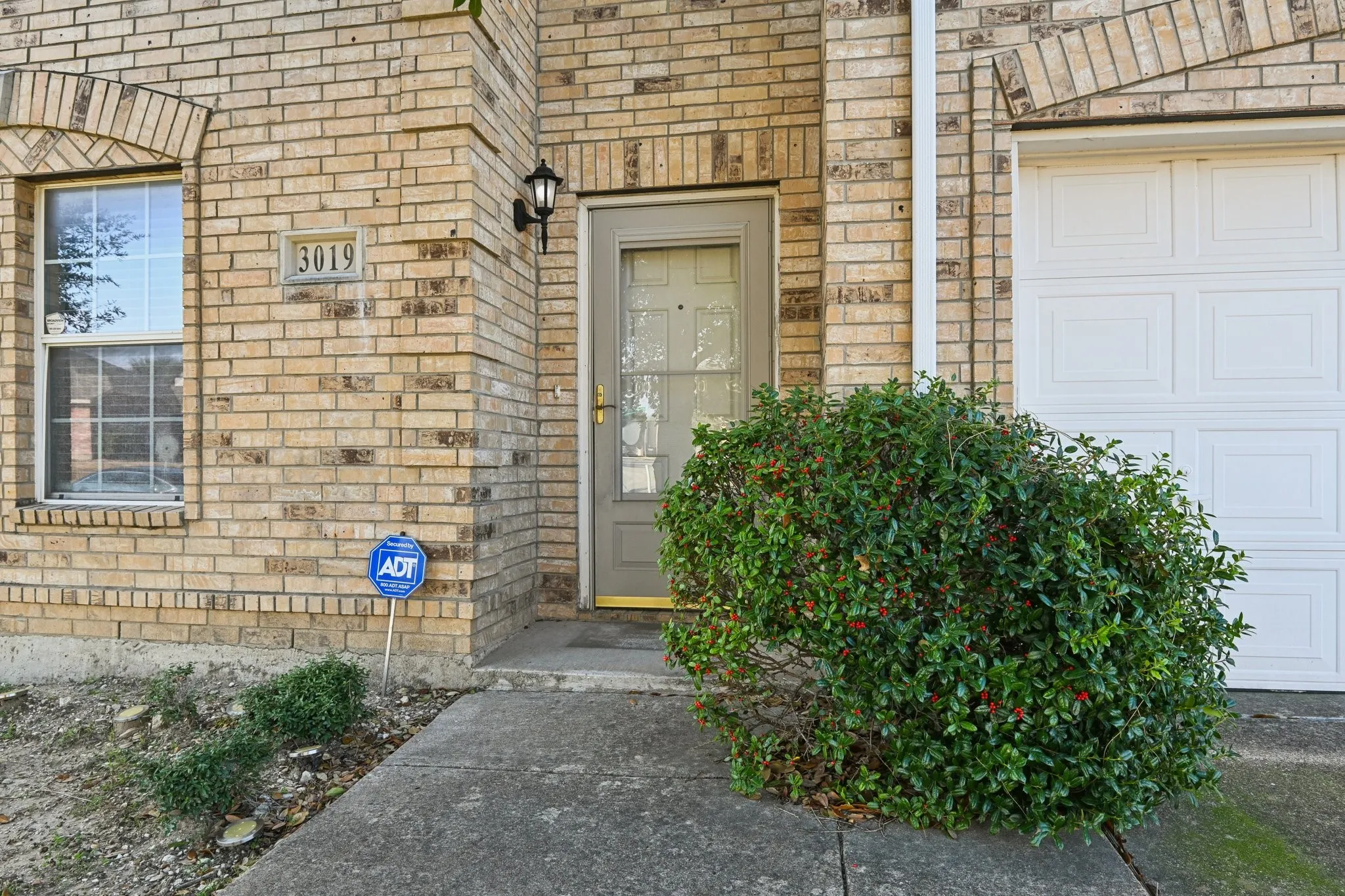 Doorway to property with a garage