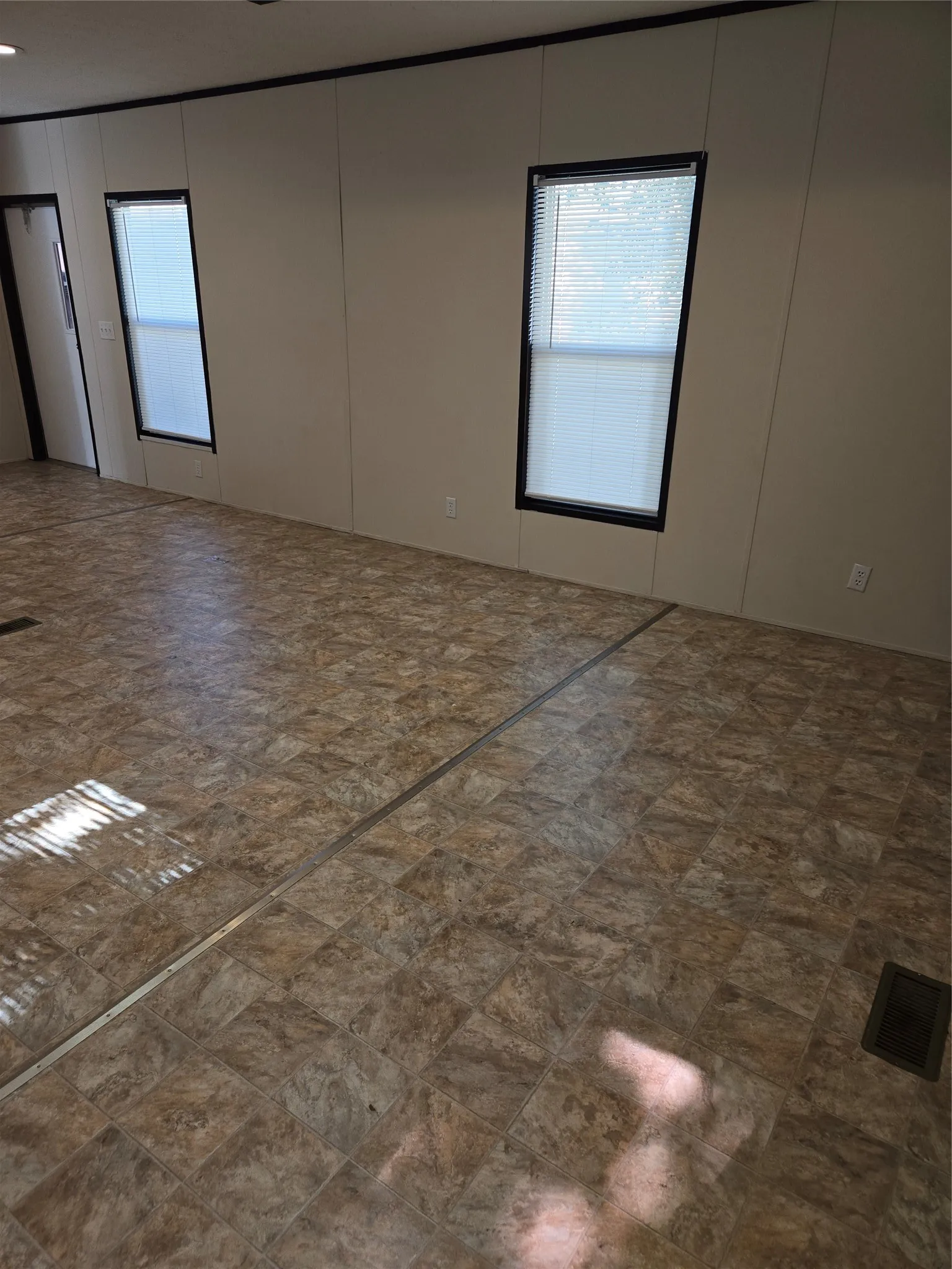 Interior space featuring two windows with white horizontal blinds