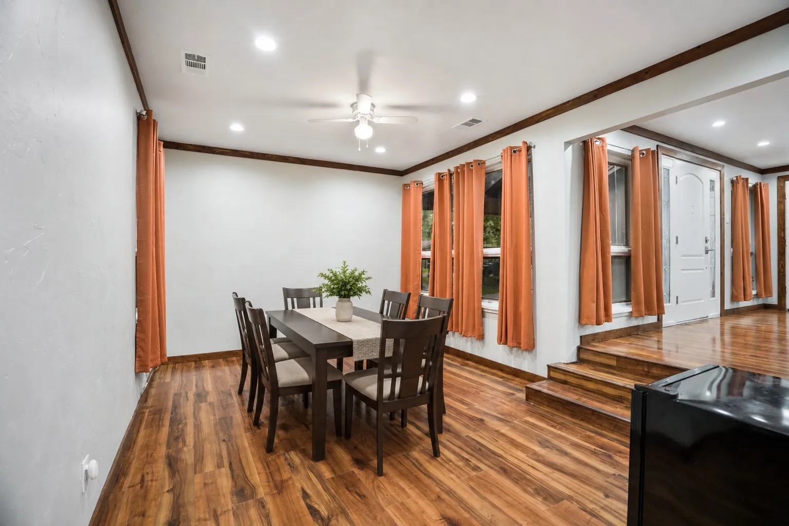 Virtually staged to give appeareance-Open dining space featuring wood-finish flooring, recessed lighting, and a ceiling fan