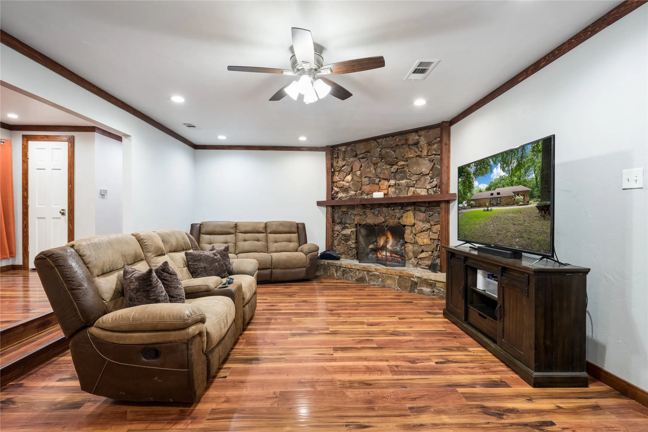 Stone-faced fireplace with a wood mantel and hearth