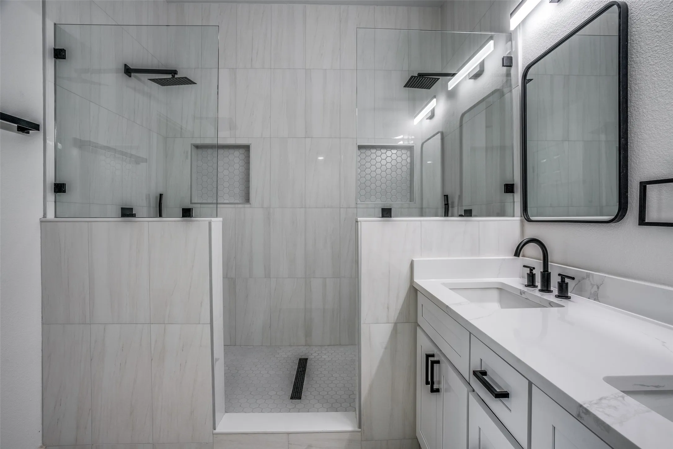 Bathroom with a tile shower and double vanity