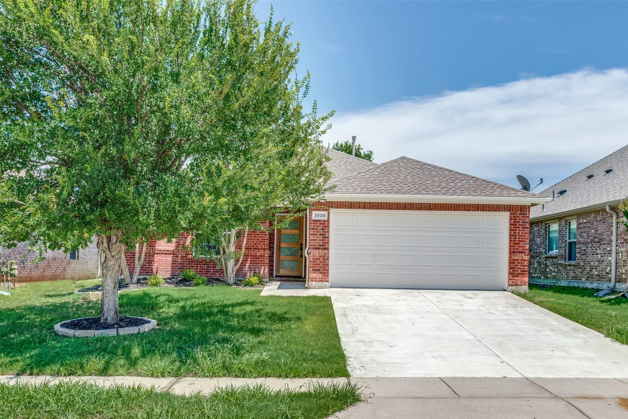 View of front of home featuring a garage and a front lawn