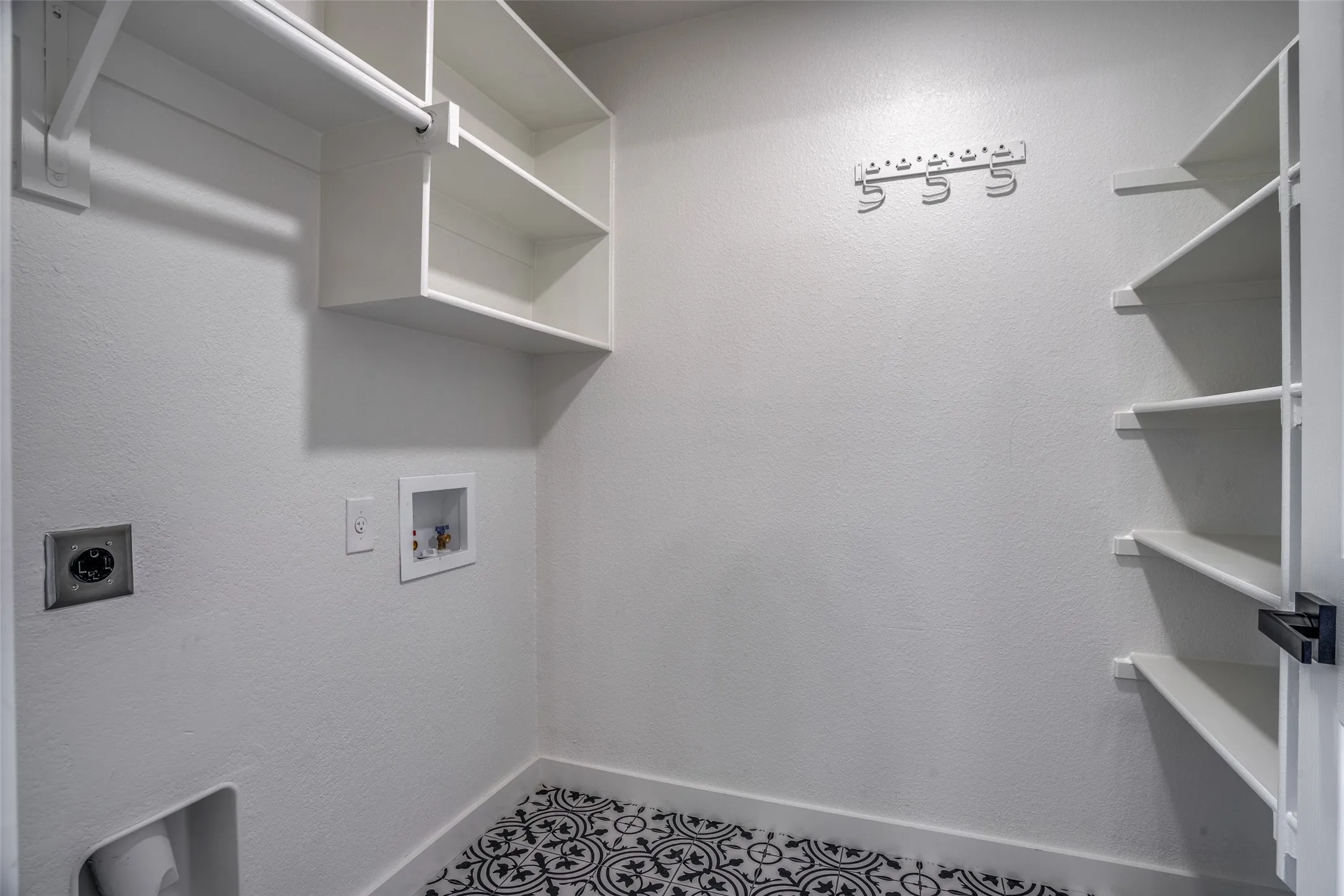 Laundry area featuring tile flooring, hookup for an electric dryer, and hookup for a washing machine