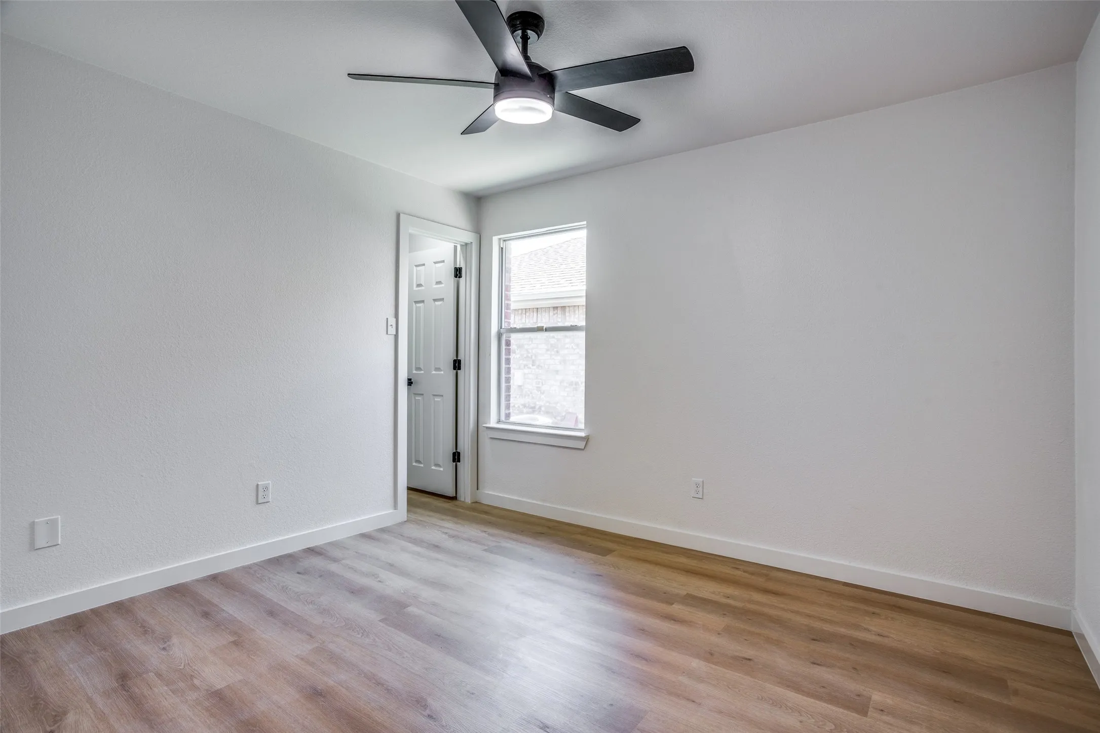 Empty room featuring light hardwood / wood-style floors and ceiling fan