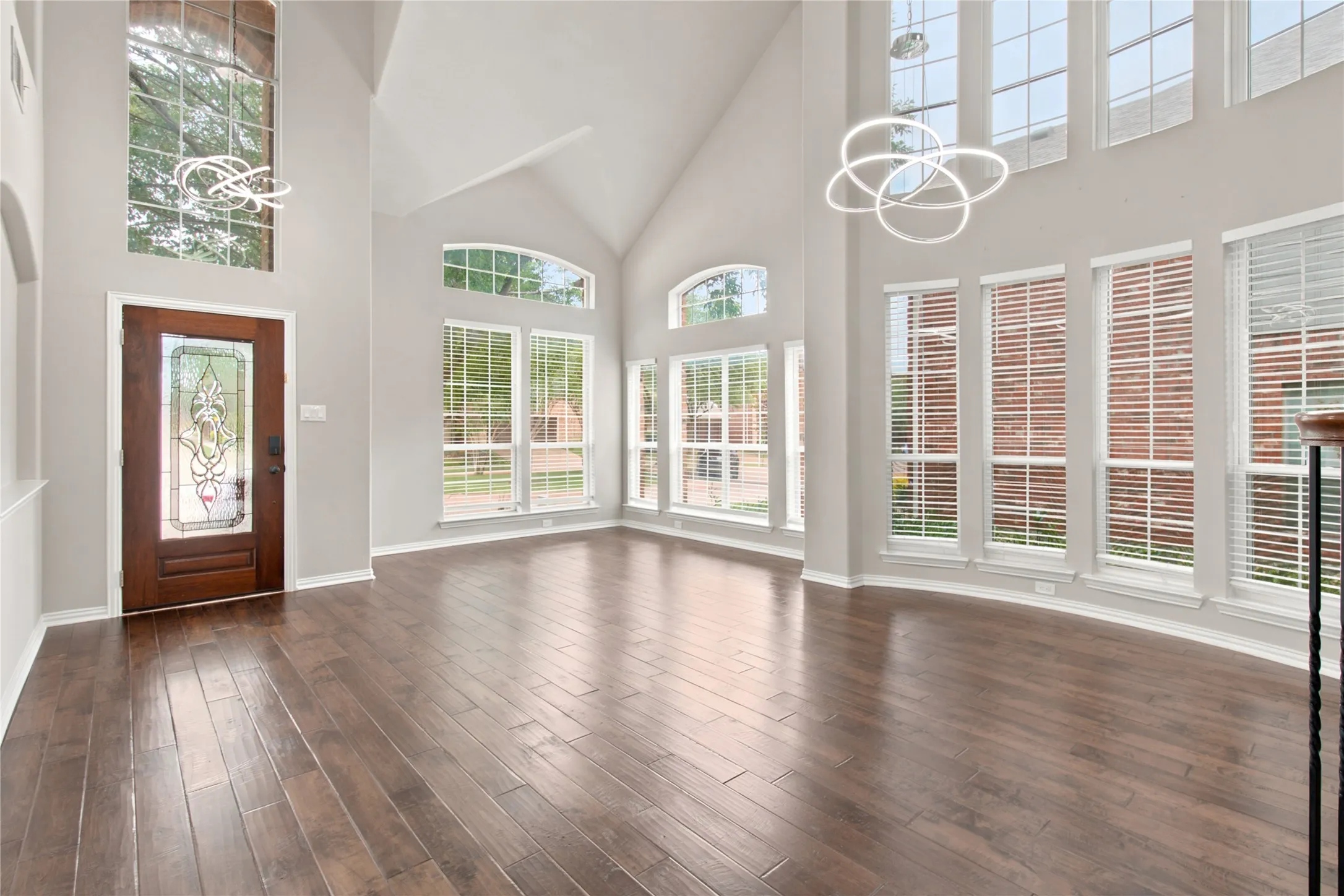 Soaring ceilings with contemporary chandelier lighting