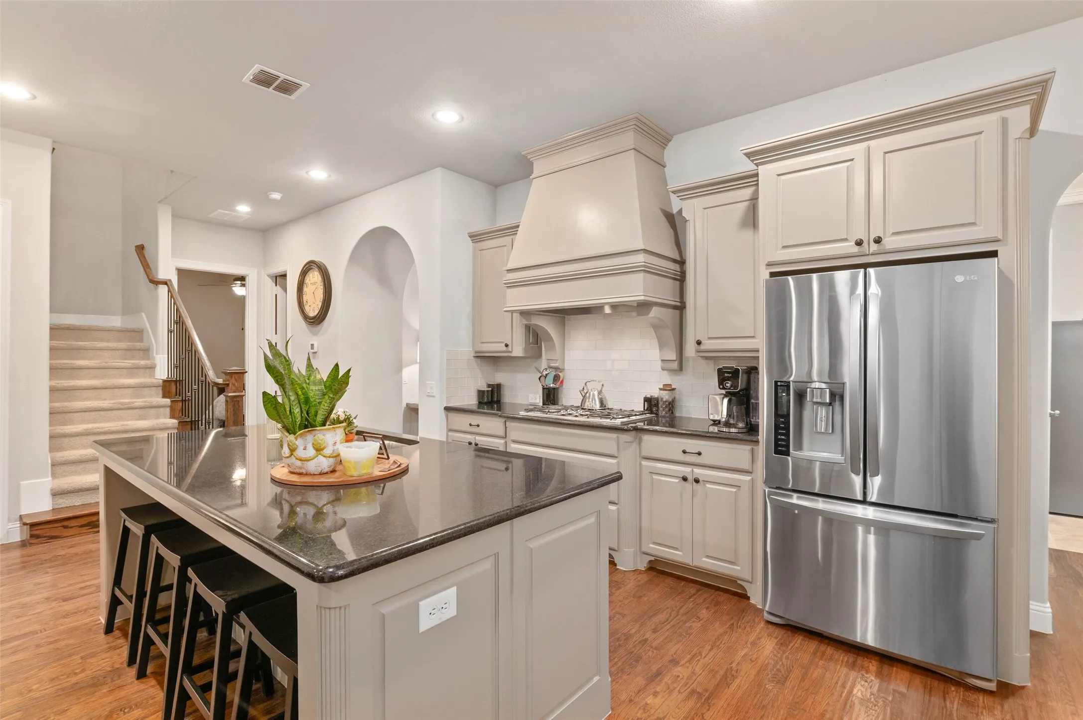 Beautiful open concept floor plan with large kitchen island, upgraded appliances and hardwood flooring.