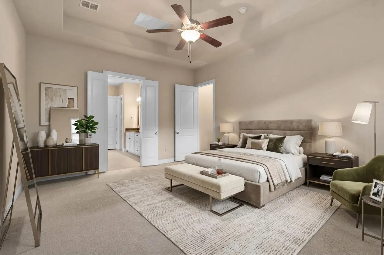 Virtually staged primary bedroom with carpeted flooring, ceiling fan and en-suite bath.
