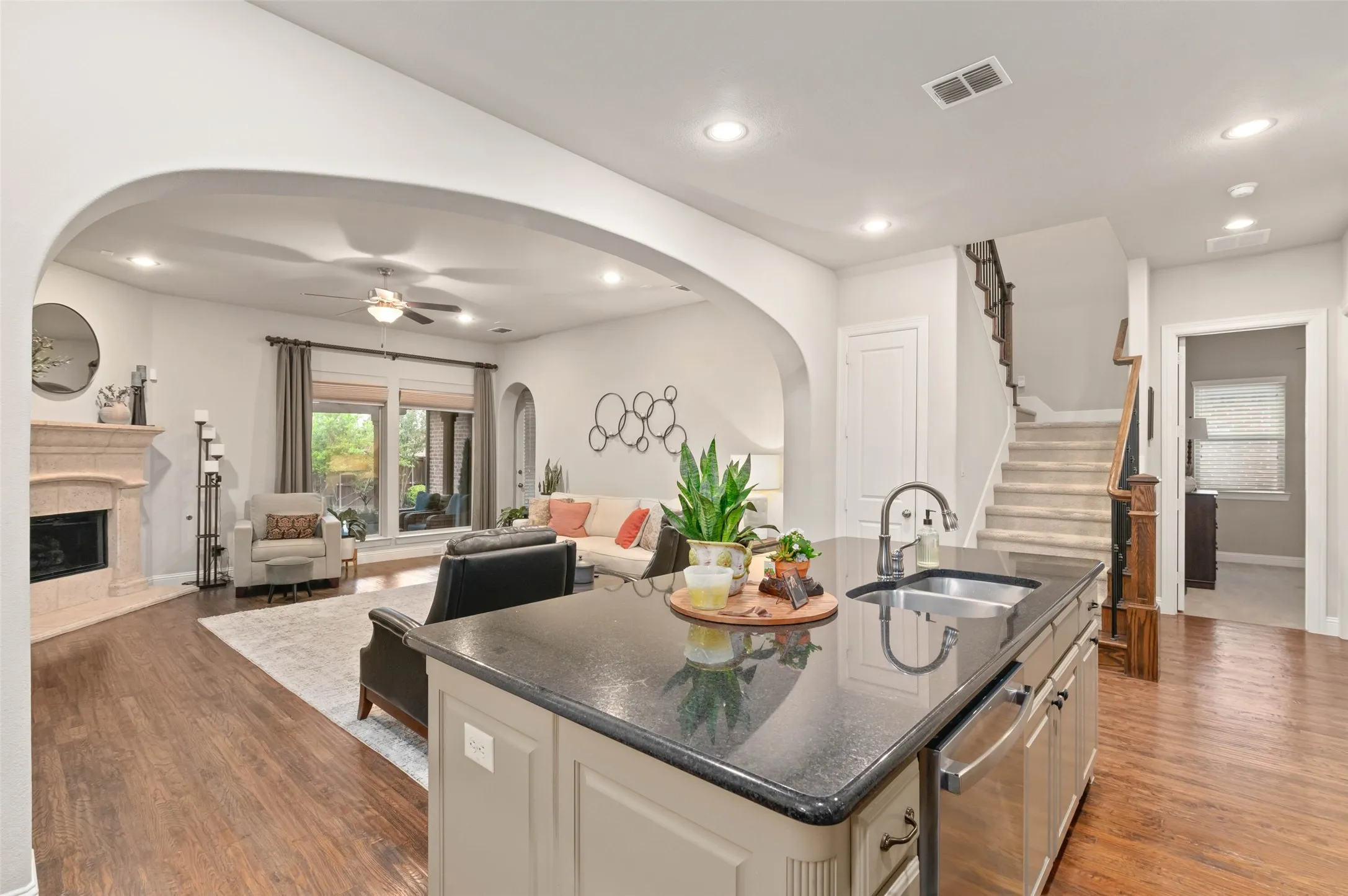 Beautiful open concept floor plan with large kitchen island, upgraded appliances and hardwood flooring.