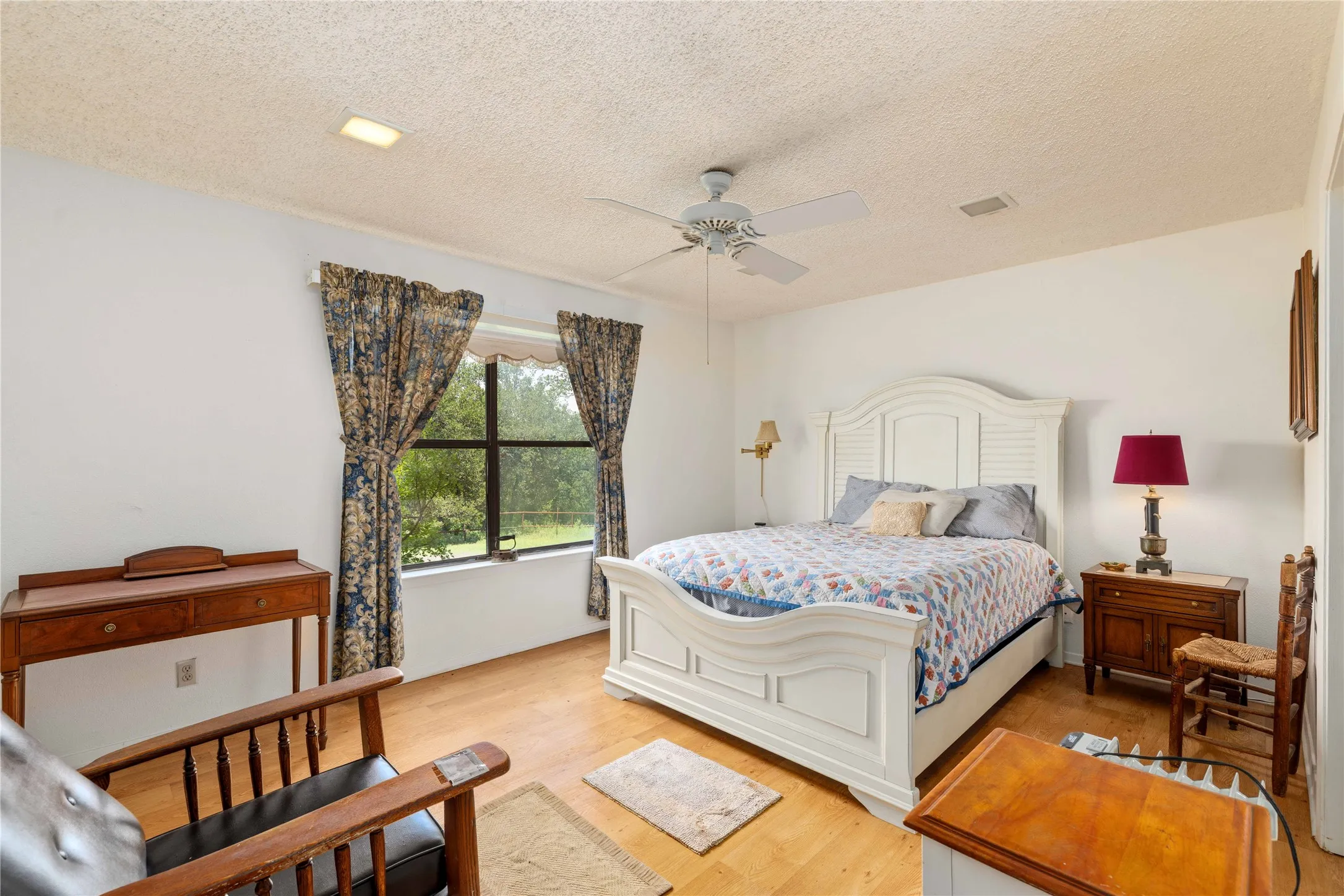 Room featuring wood-finish flooring, a ceiling fan, and recessed lighting