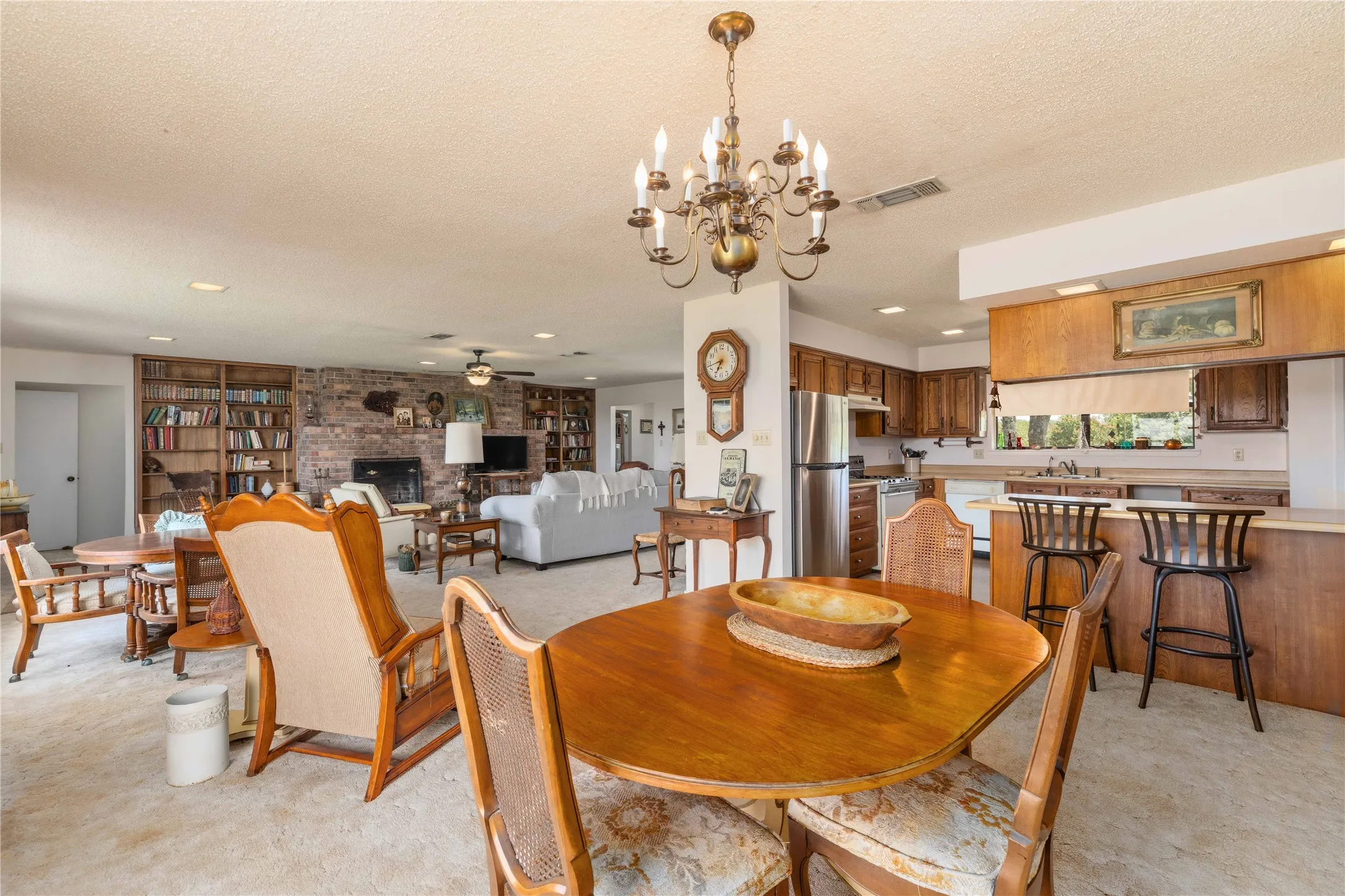 Open-concept interior featuring a dining area, kitchen, and living room