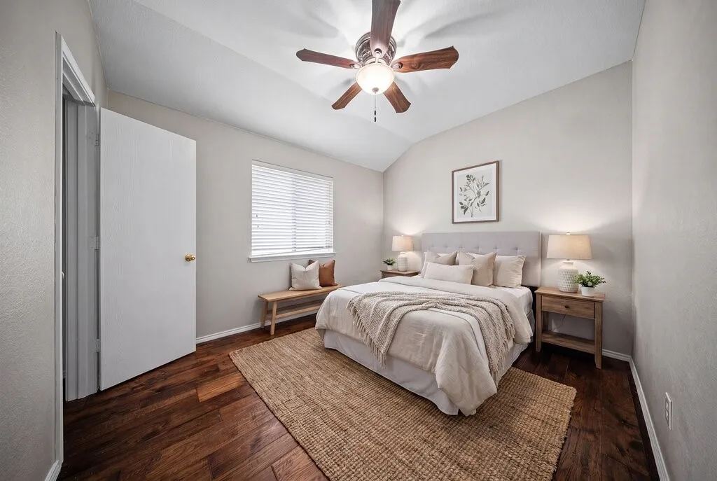 Vaulted ceiling with a wood-finish ceiling fan and light fixture
