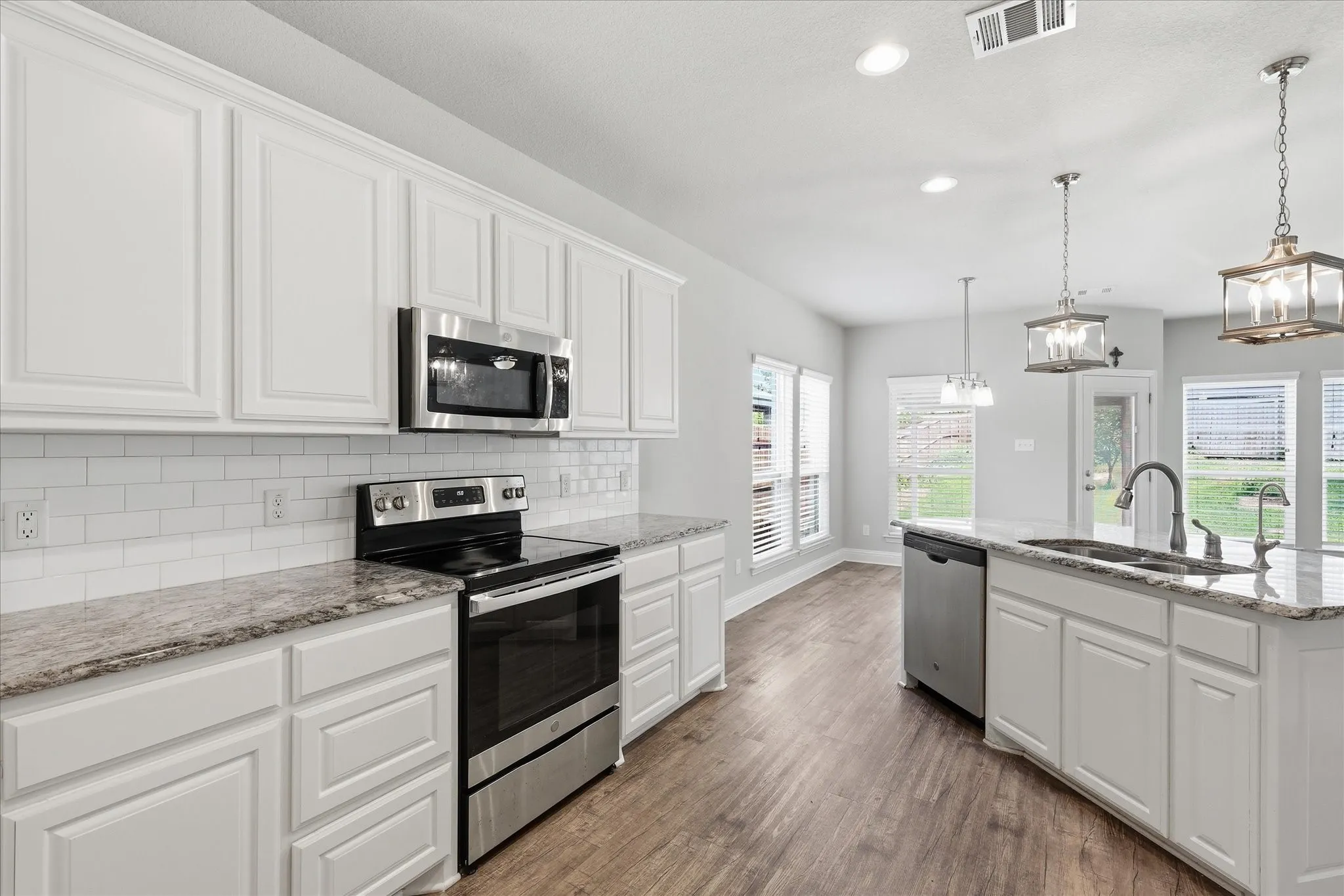 The heart of the home, this stunning open-concept kitchen features granite countertops, stainless steel appliances, abundant cabinetry, a spacious island, and seamless flow into the dining and living areas—perfect for everyday living and entertaining.