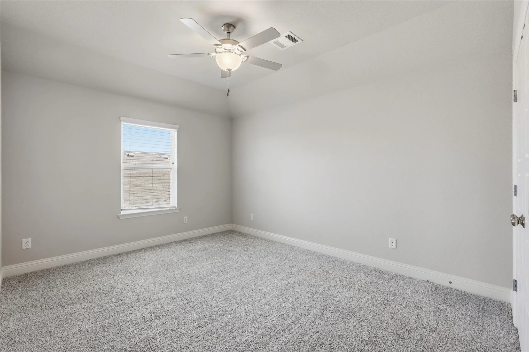 Comfortable secondary bedroom featuring neutral finishes, natural light, and flexible space for family, guests, or a home office.