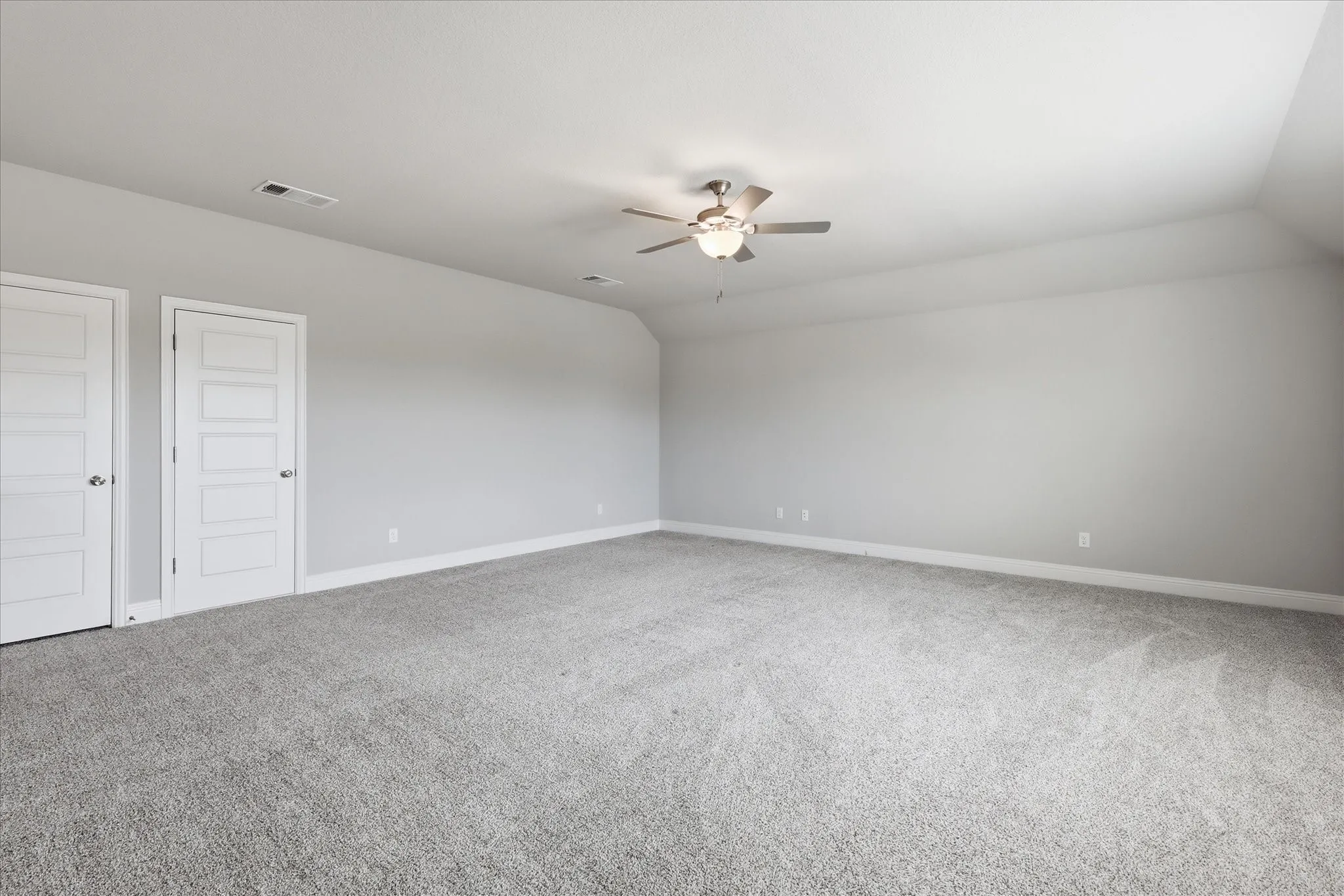 Generously sized primary suite with abundant space for a seating area, home workspace, or personal retreat.