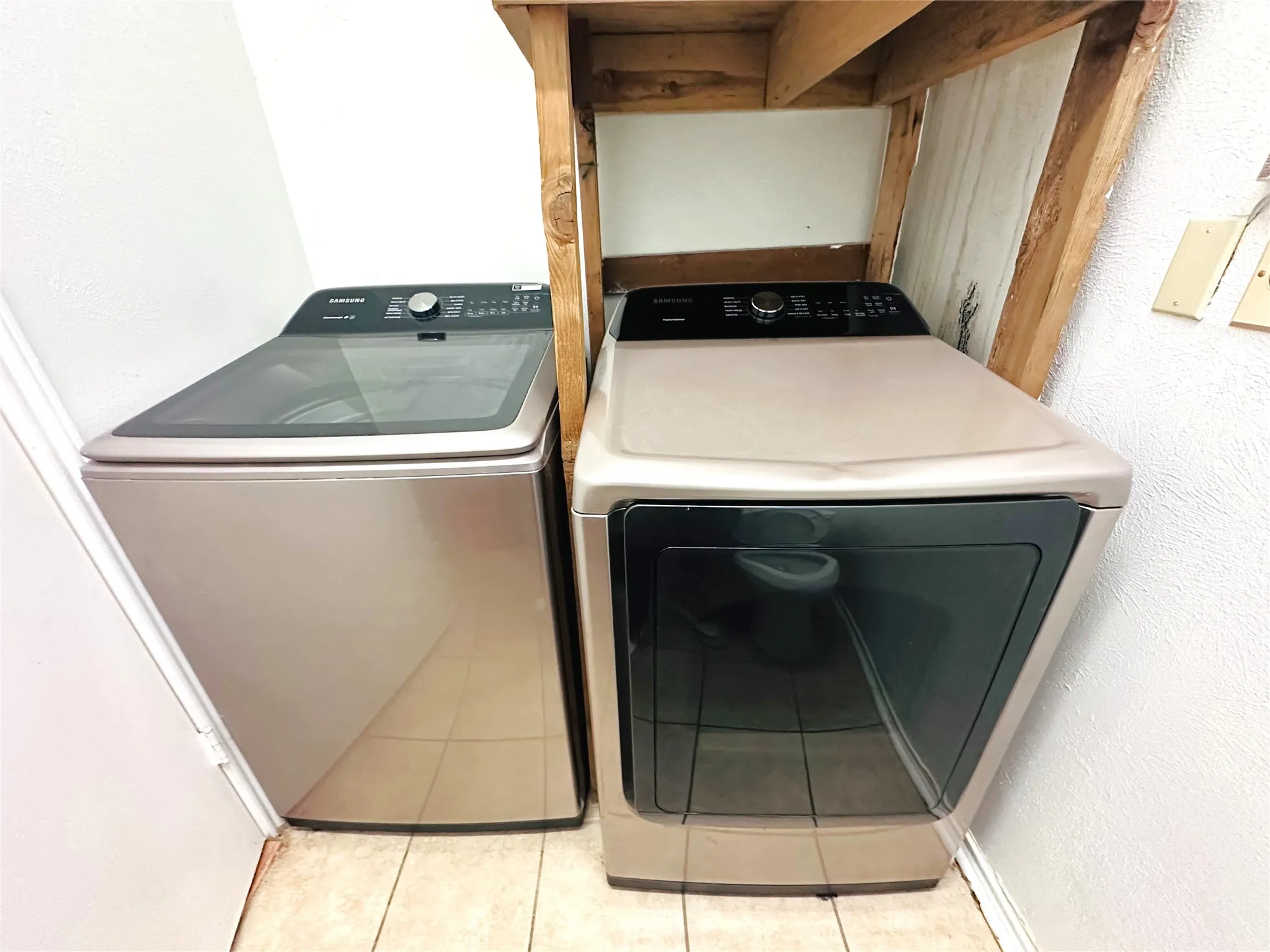 Dedicated laundry area featuring a top-load washer and front-load dryer