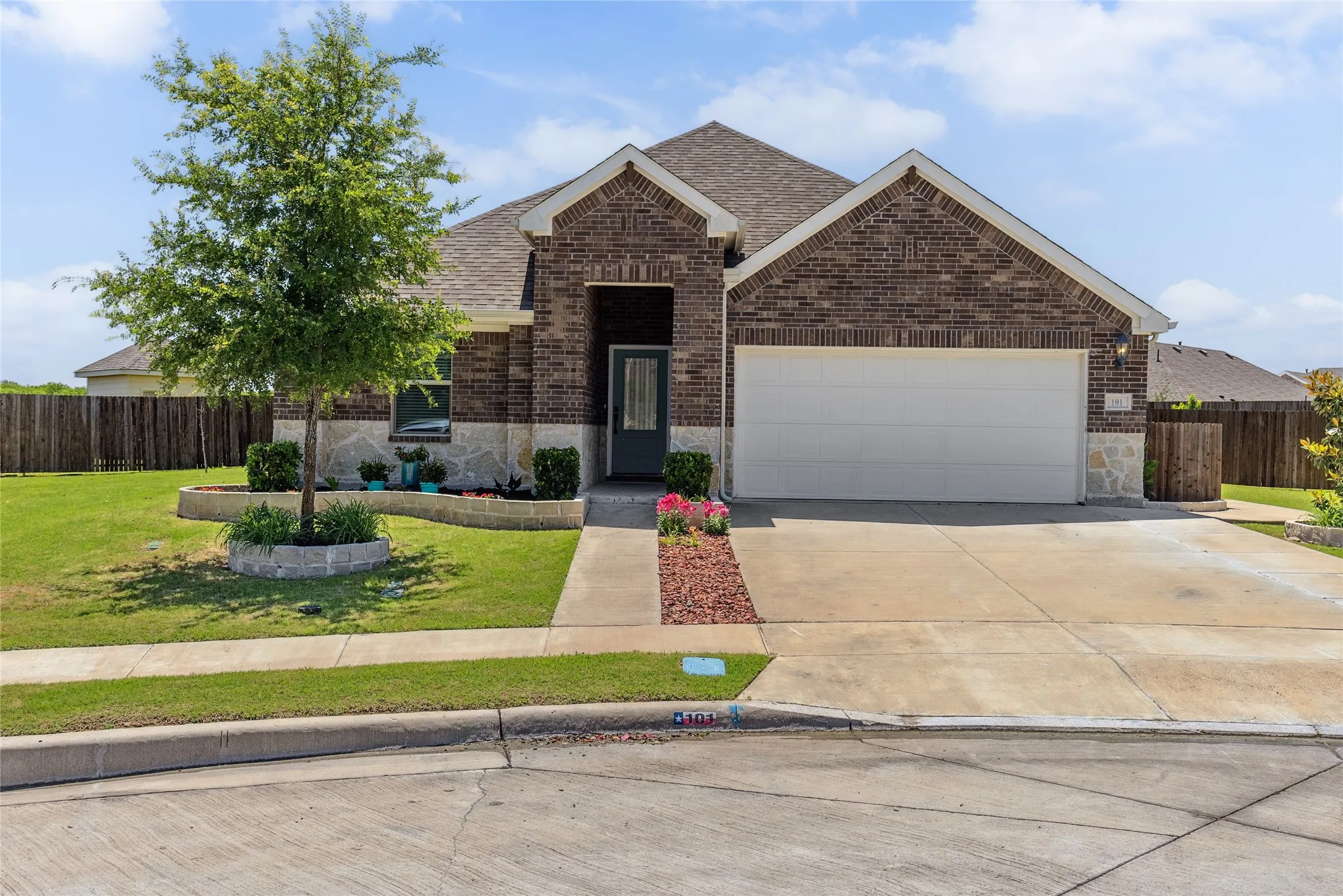 Brick exterior with stone accents and a two-car garage