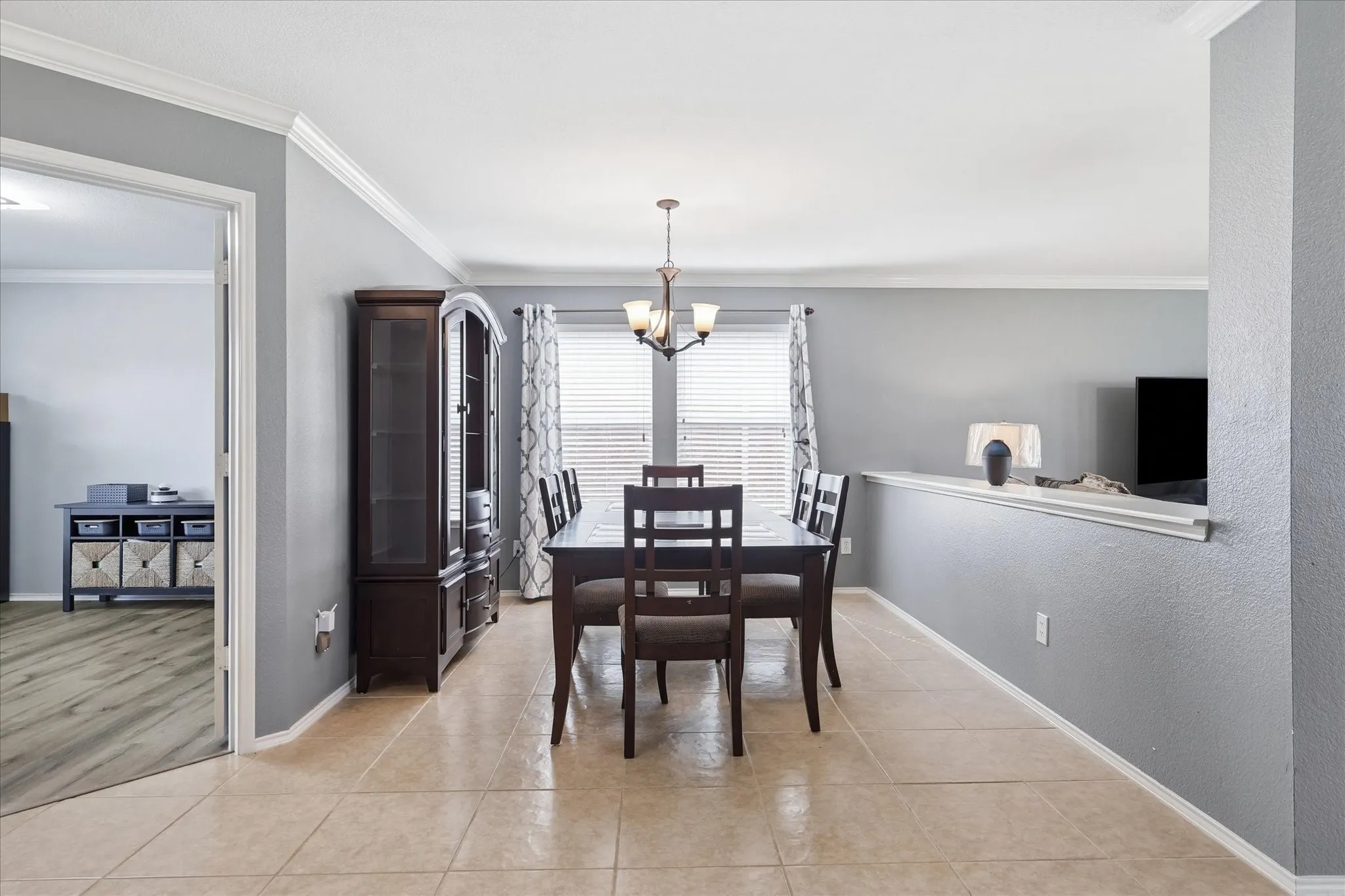 Dining area featuring neutral-toned tile flooring and painted walls