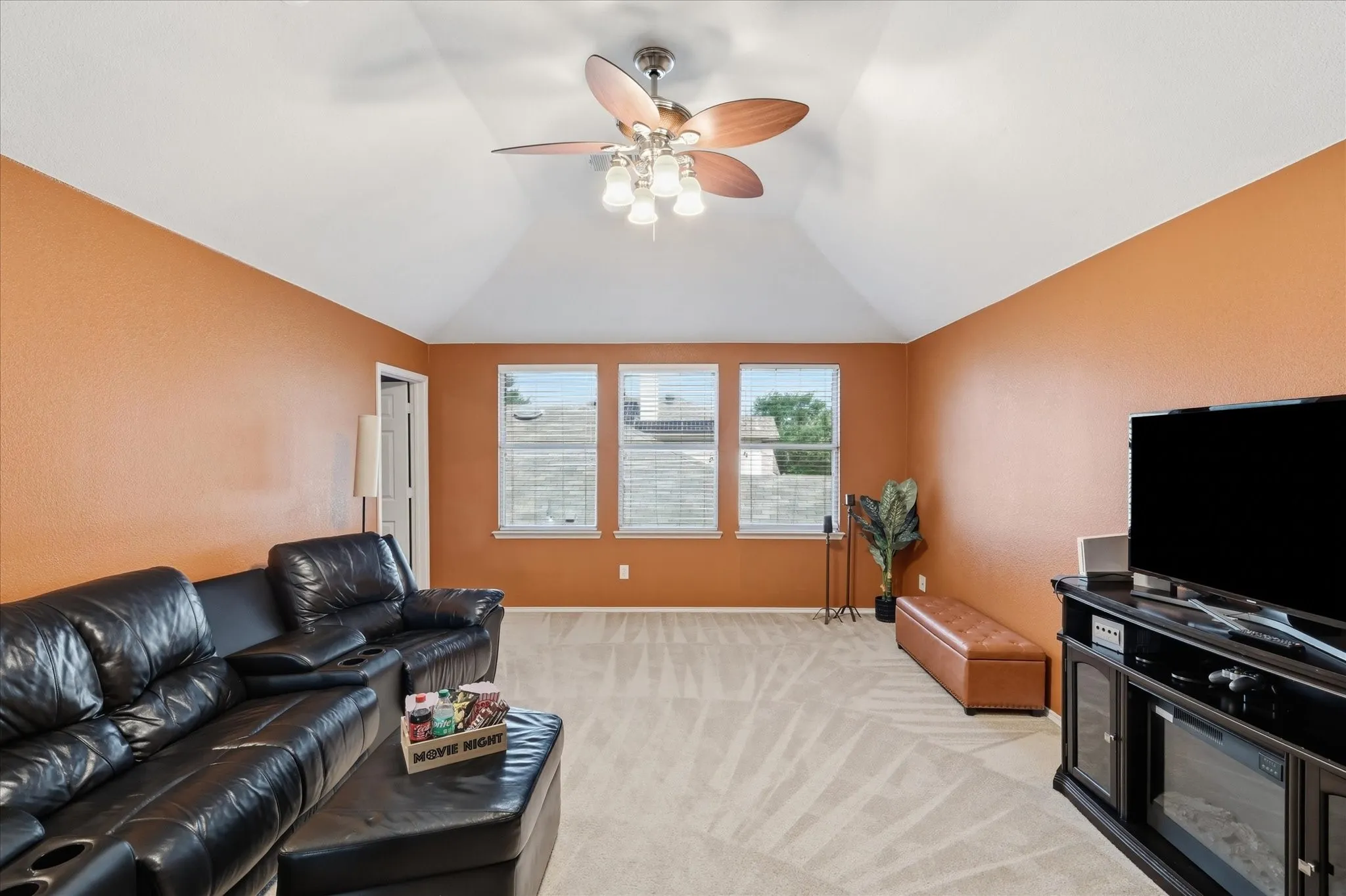 Vaulted ceiling with a ceiling fan featuring integrated lighting