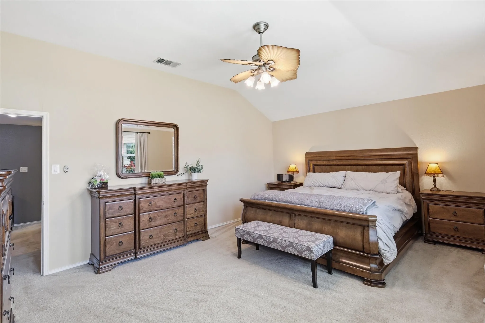 Vaulted ceiling with a ceiling fan featuring shell-shaped light fixtures