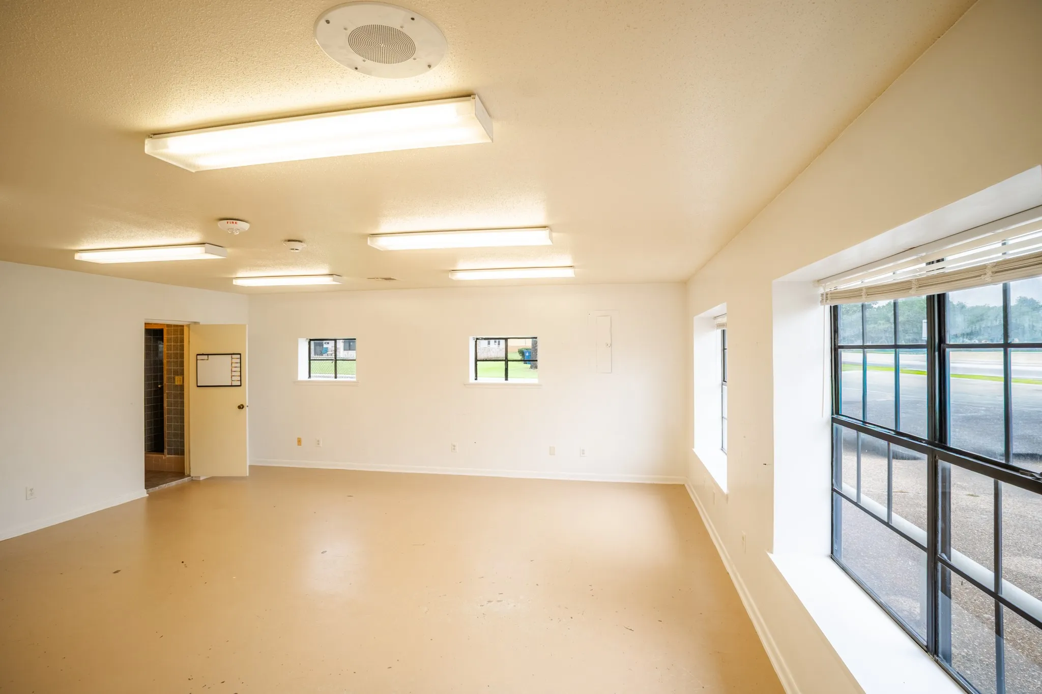 Spacious room featuring light-toned flooring and white walls