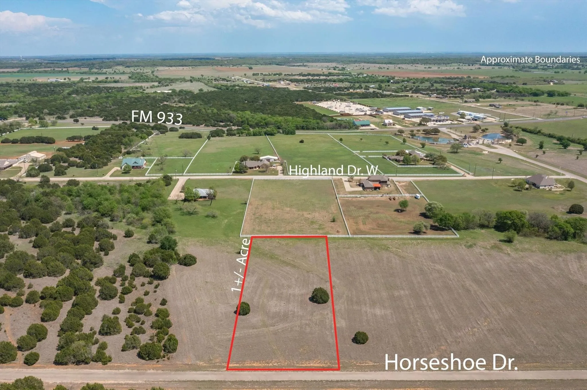 Expansive 1+/- acre lot featuring a clear buildable area and scattered mature trees