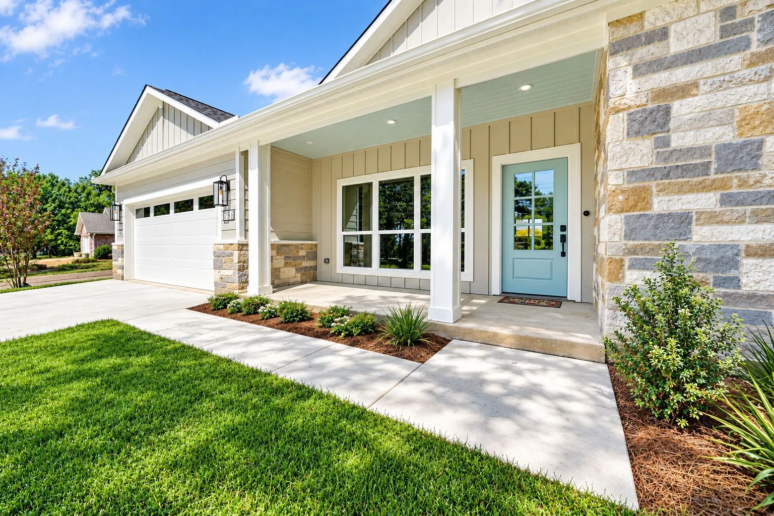 Stone and siding exterior with a light blue entry door