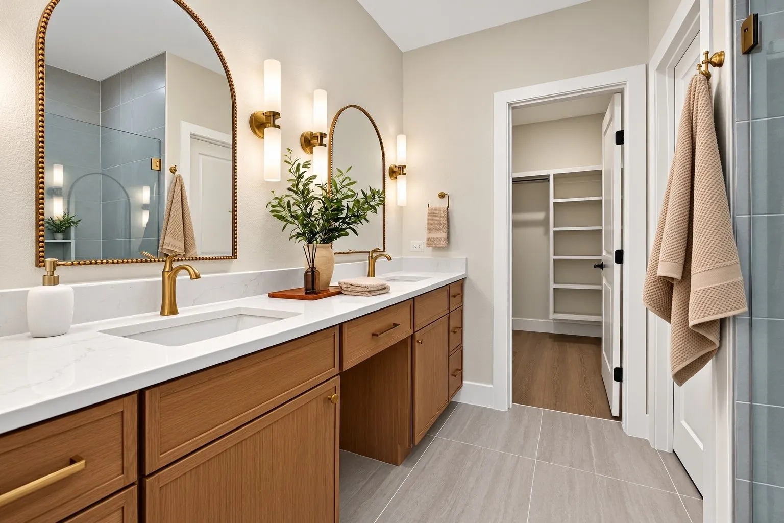 Dual vanity with a white countertop and gold-finish faucets