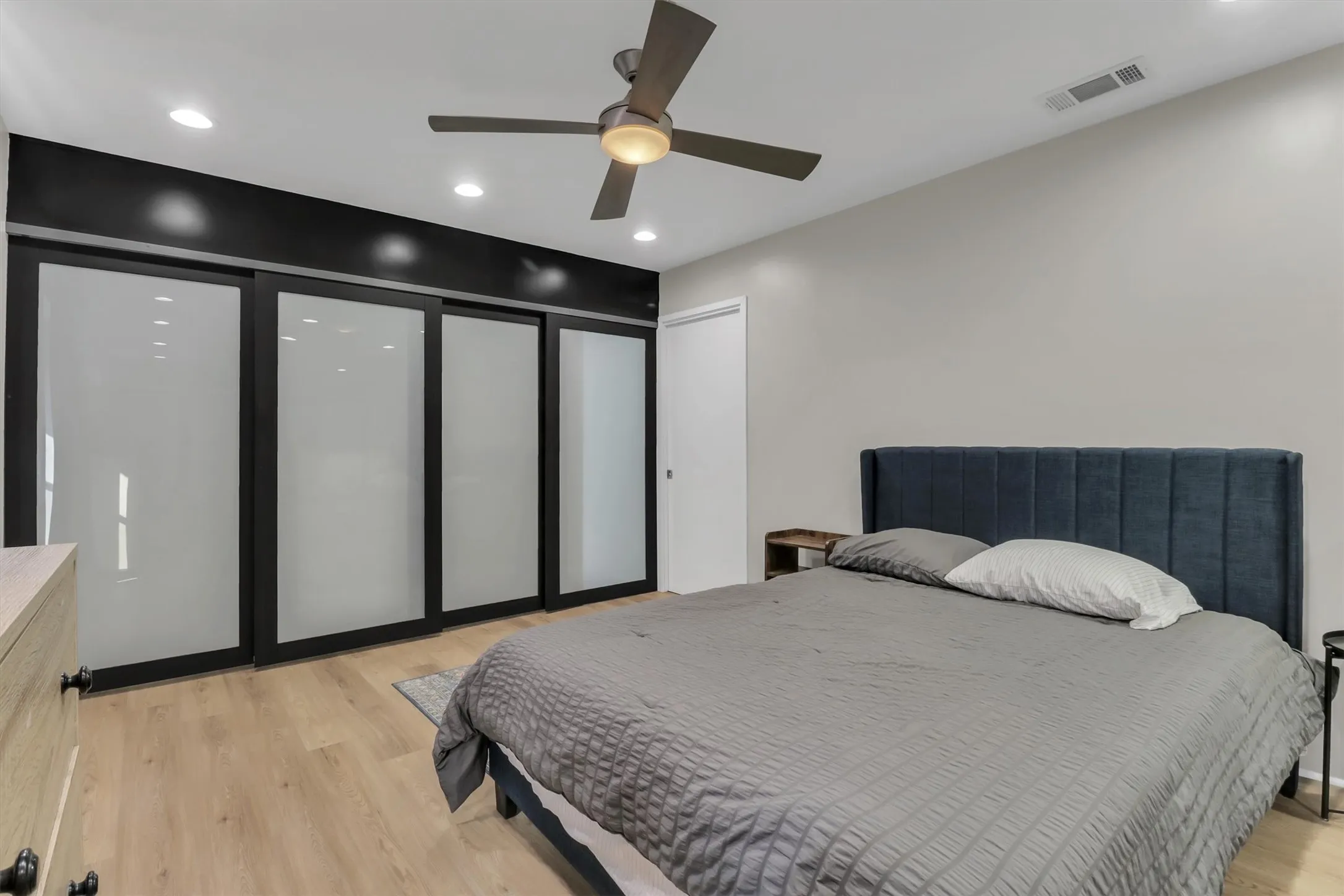 Bedroom featuring a ceiling fan with integrated lighting, recessed lighting, and wood-finish flooring