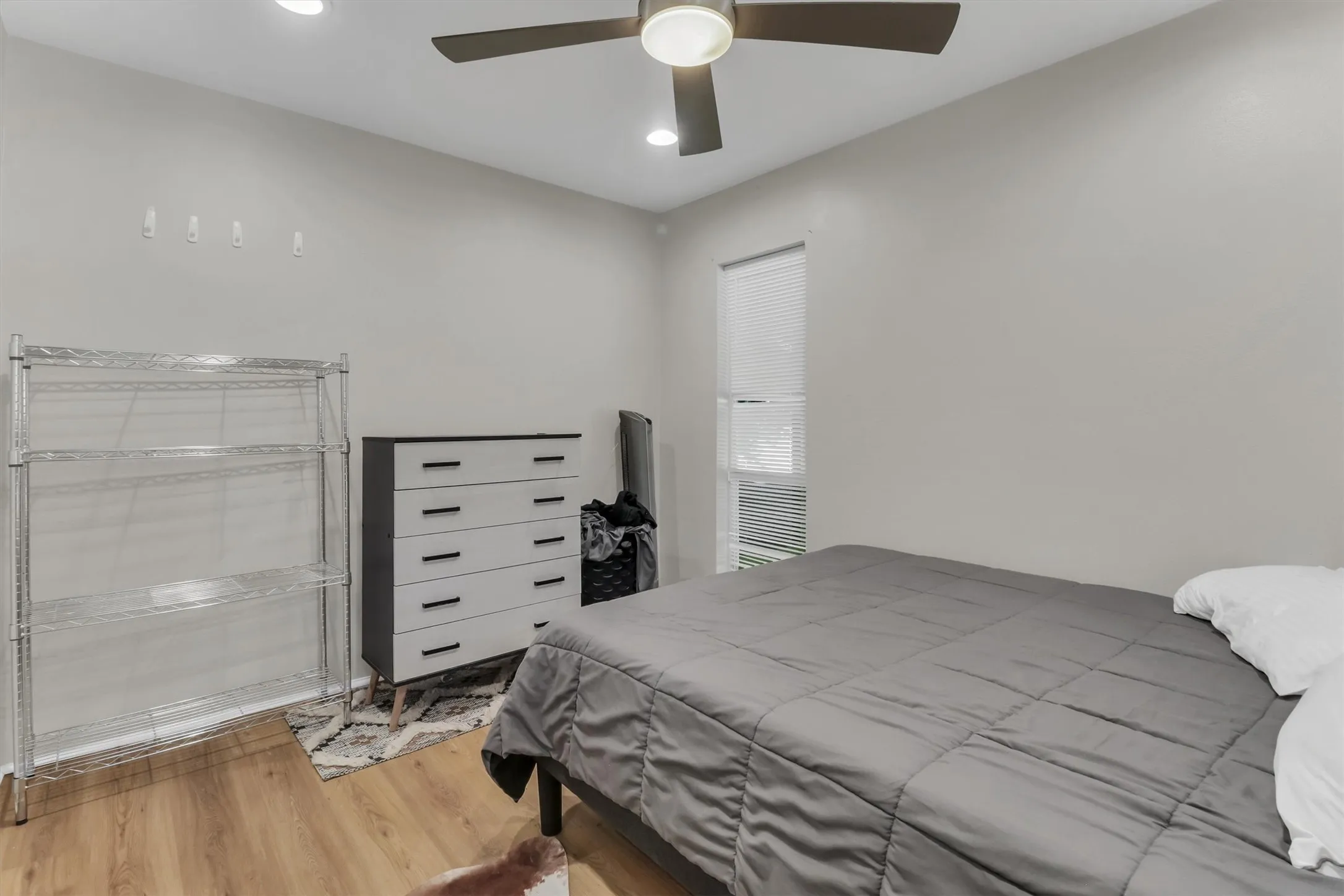 Room featuring wood-finish flooring, recessed lighting, and a ceiling fan