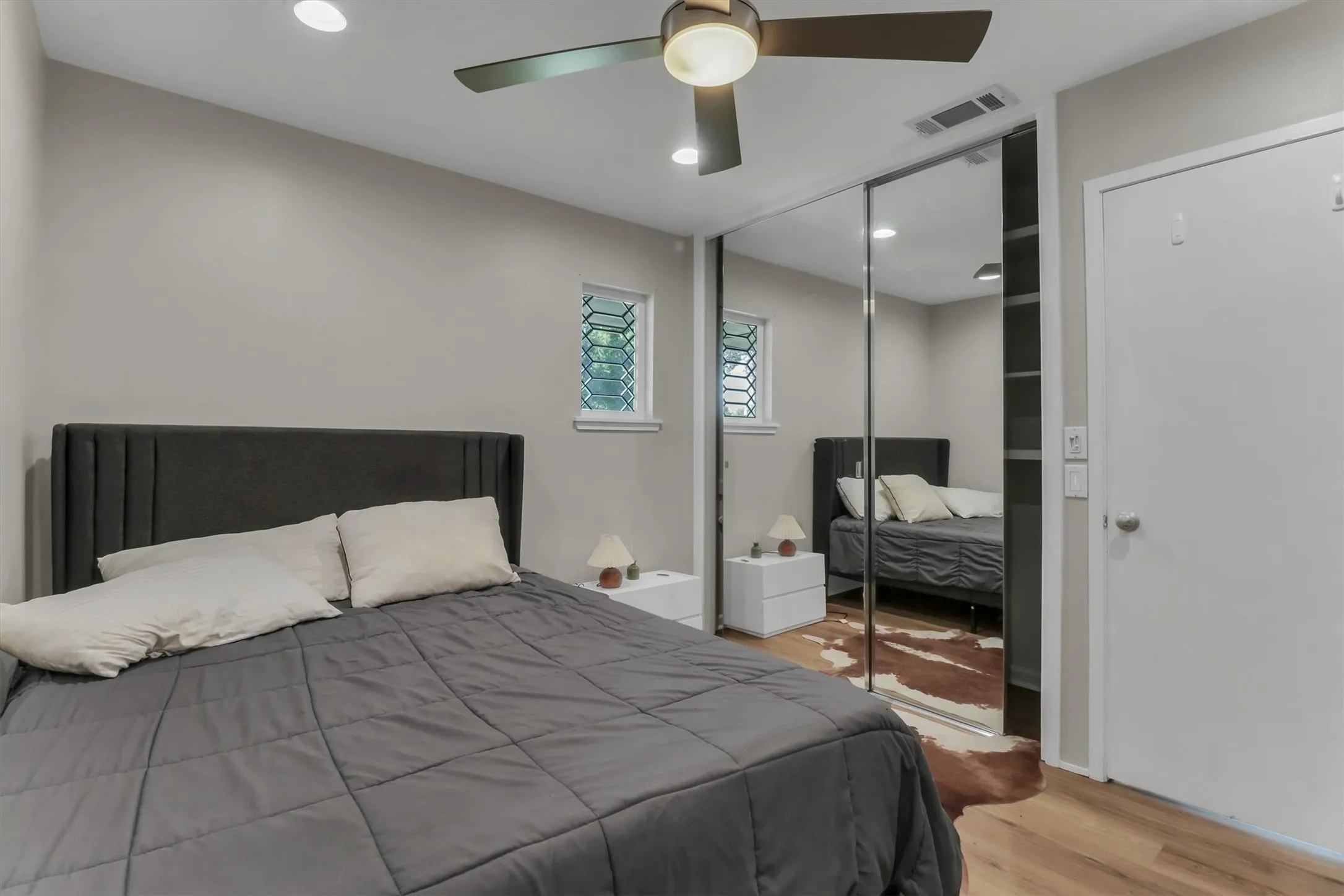 Bedroom featuring wood-finish flooring, recessed lighting, and a ceiling fan with integrated light