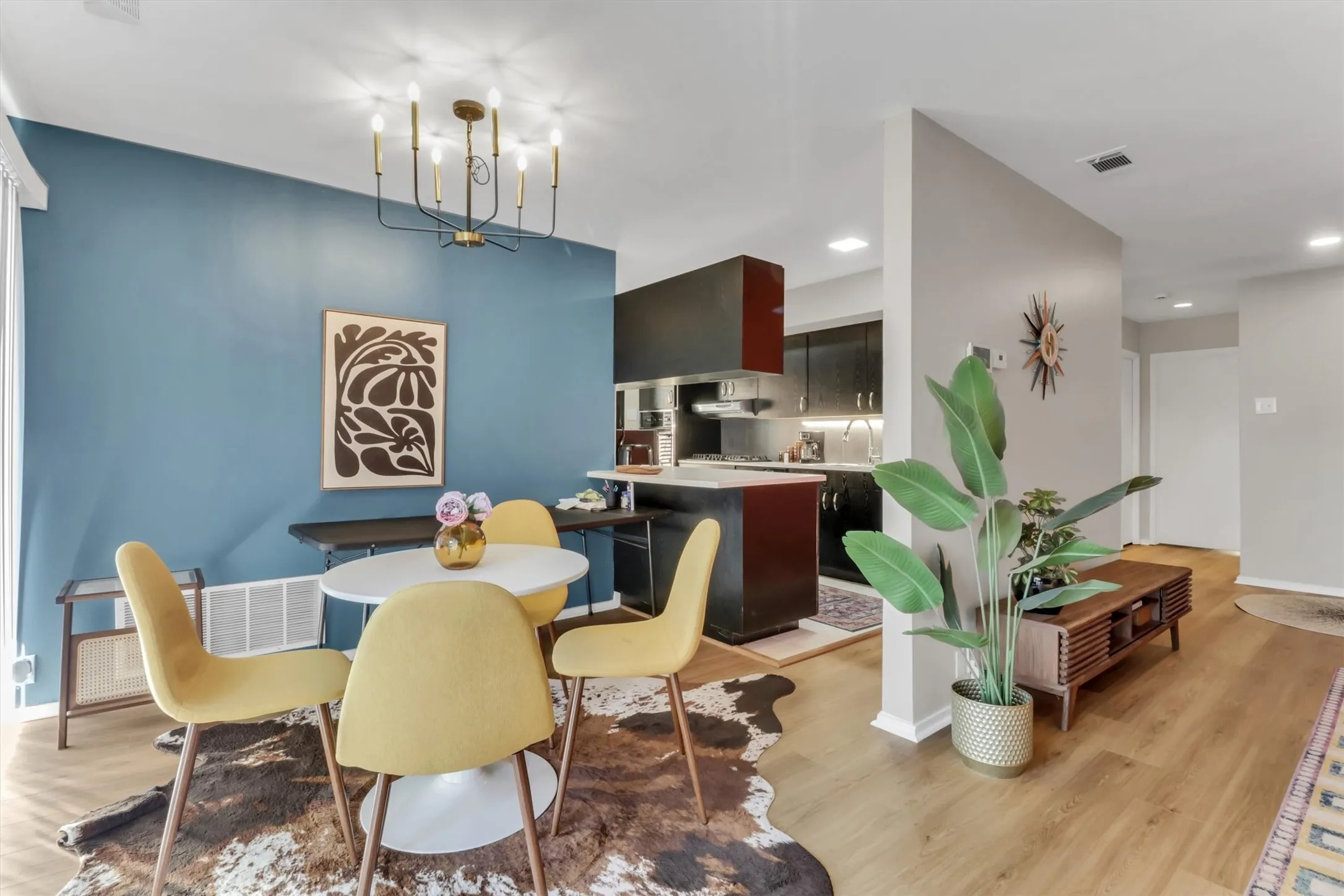 Open-concept living space featuring wood-finish flooring throughout