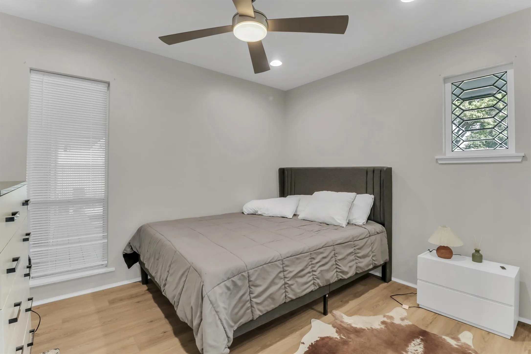 Light wood-finish flooring complements the neutral wall tones