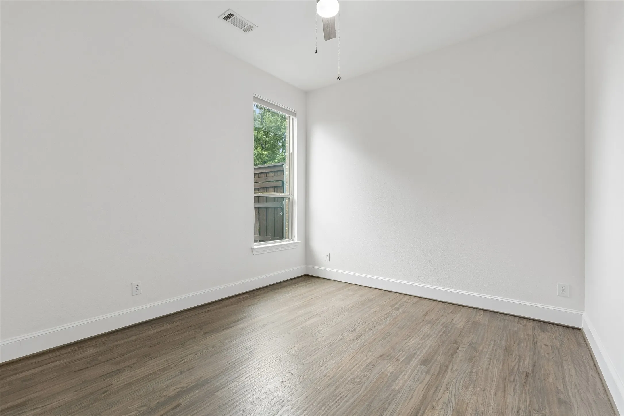 Main level guest bathroom with refinished hardwood floors and walk in closet.