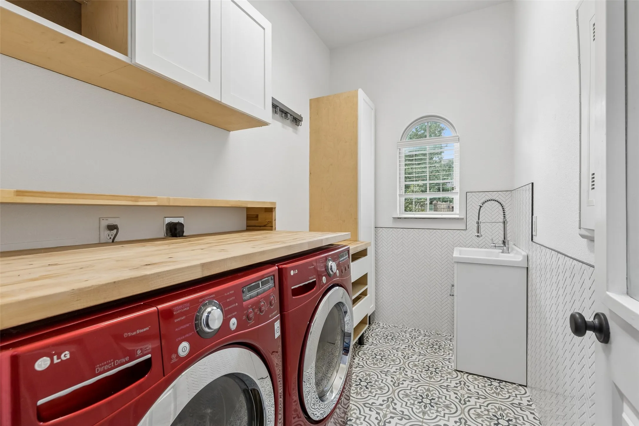 Renovated laundry room with sink.