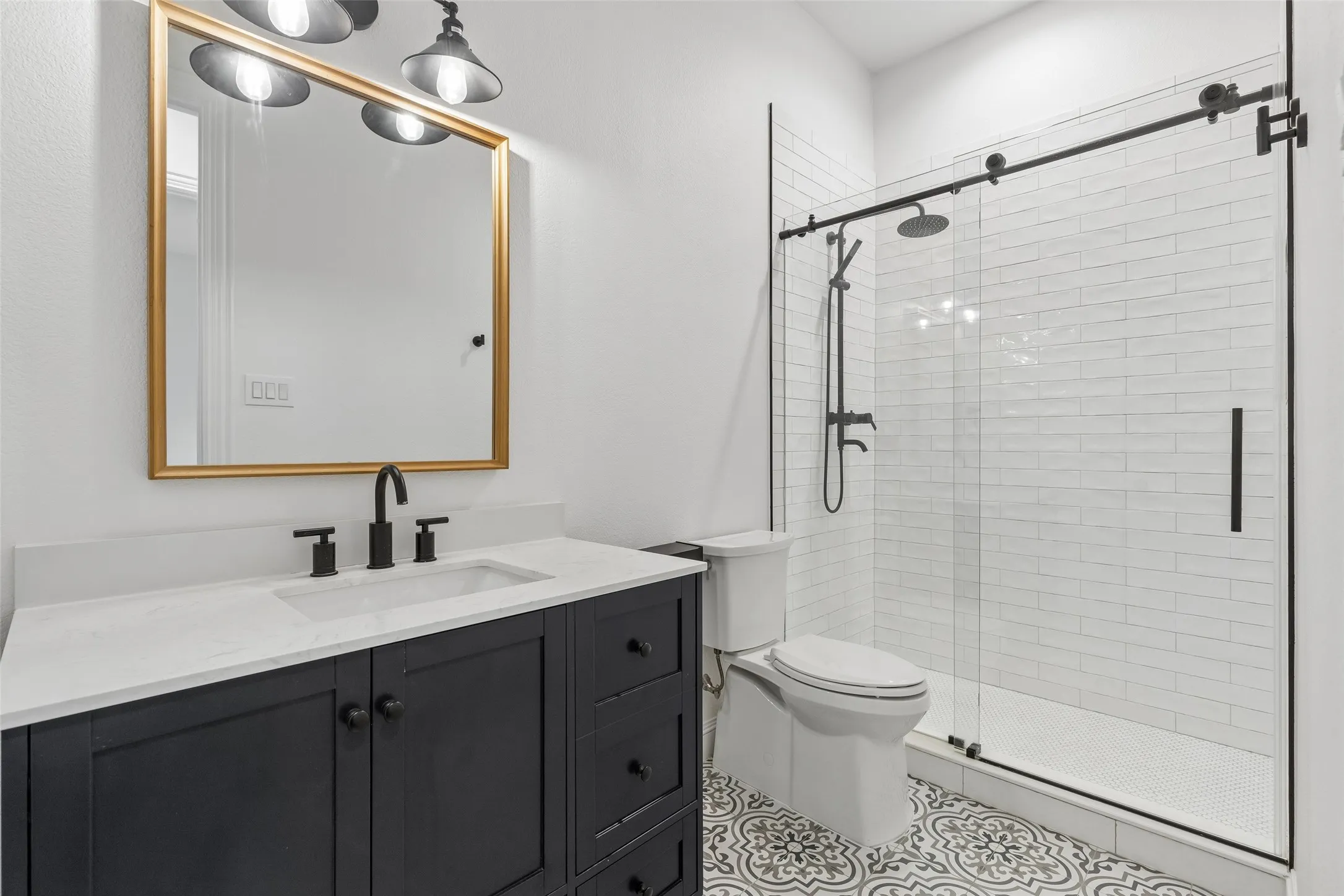 Main level renovated guest bathroom with custom vanity & walk in shower.
