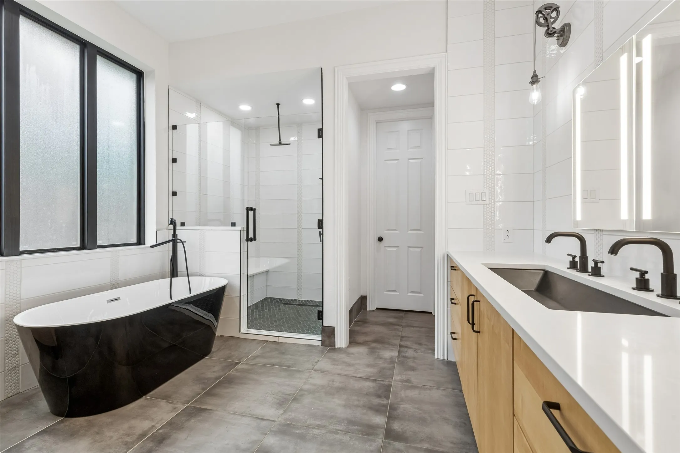 Reconfigured & renovated primary ensuite bathroom & walk in closet with custom organization.