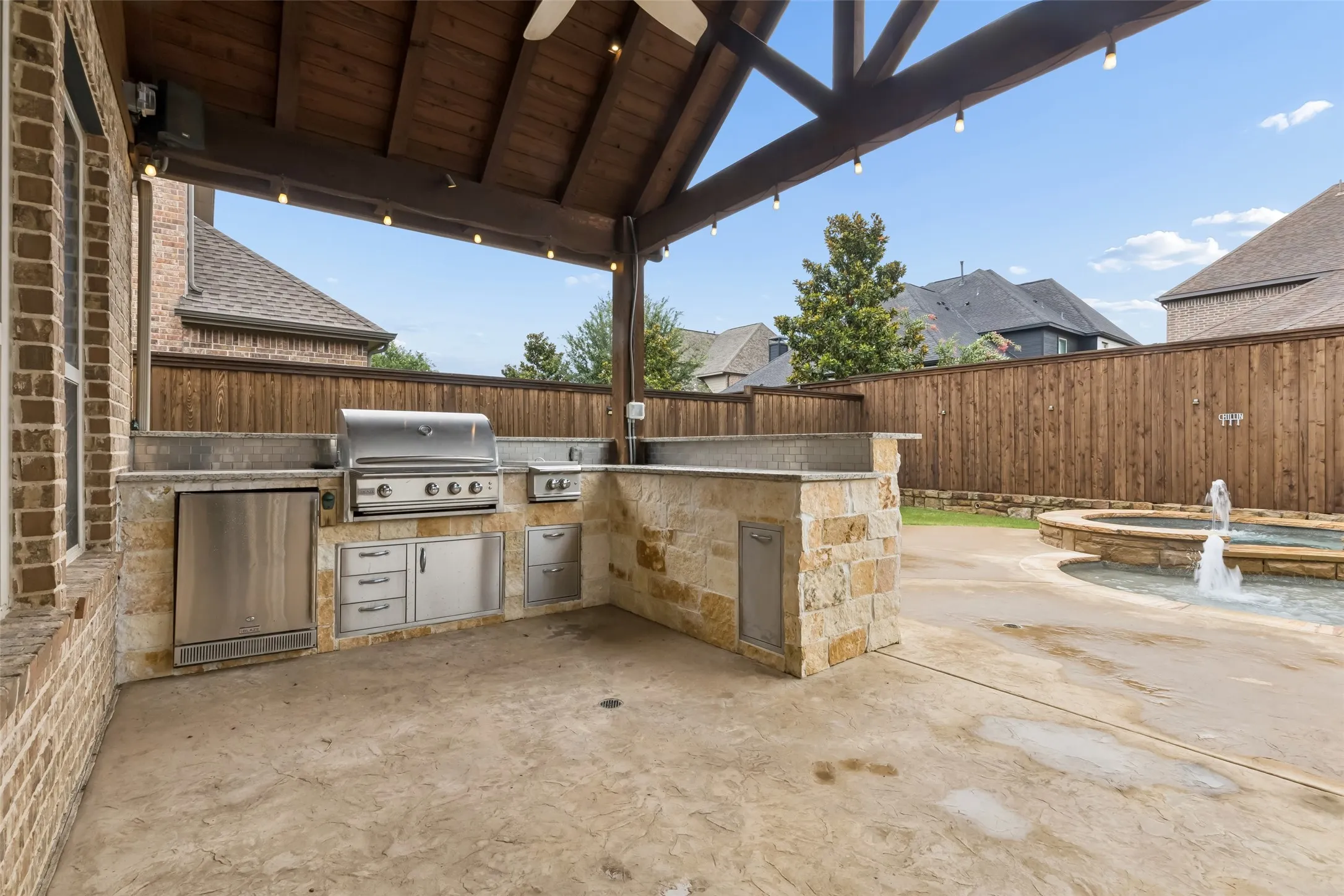 Back yard extended covered patio with built in outdoor kitchen.