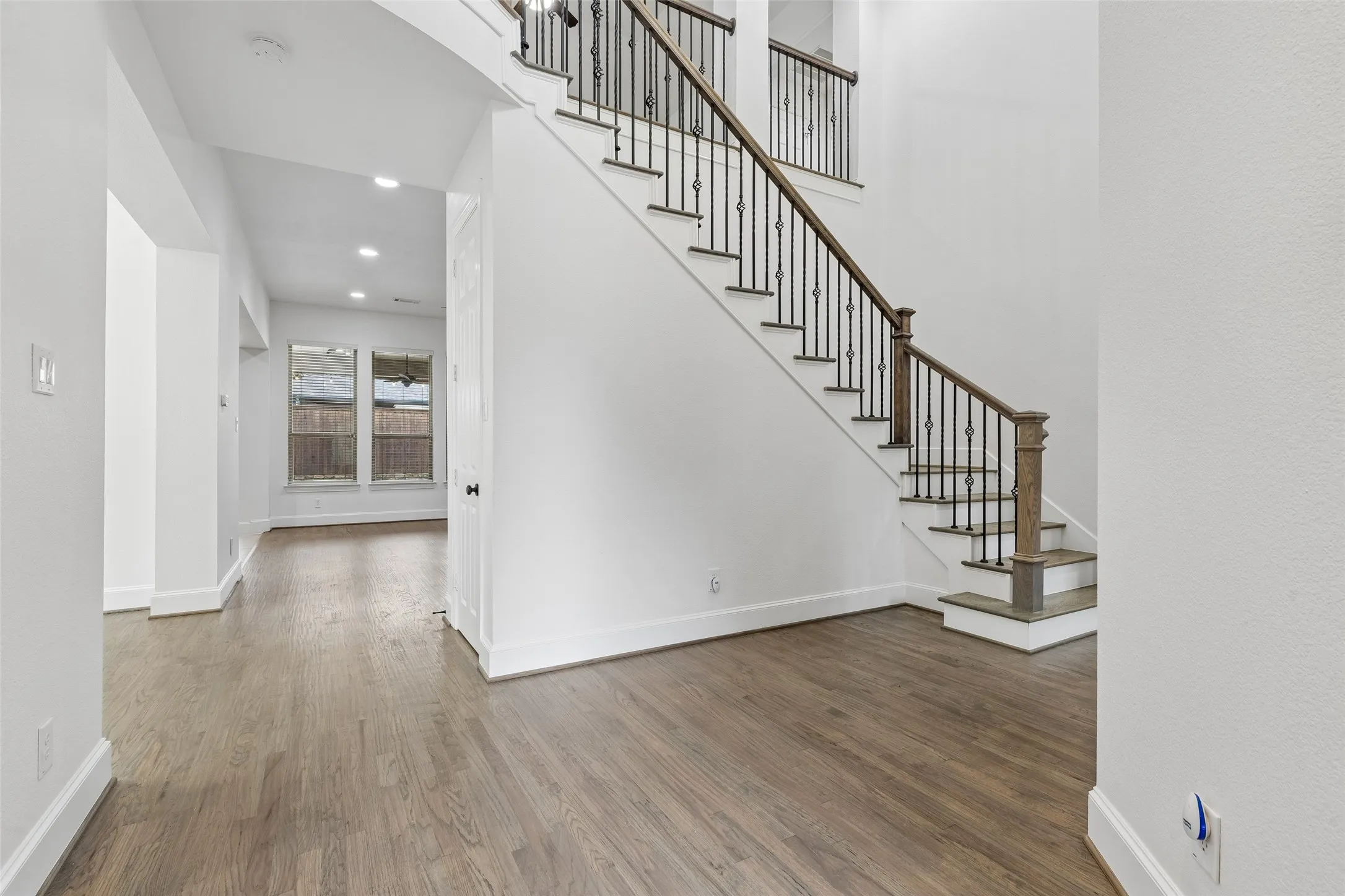 Front entry showcasing refinished hardwood floors, fresh interior paint & trim, and updated staircase.