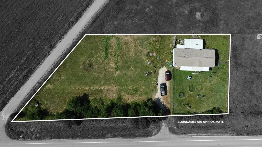 Aerial perspective showcasing a rectangular parcel with a single-story structure and an outbuilding