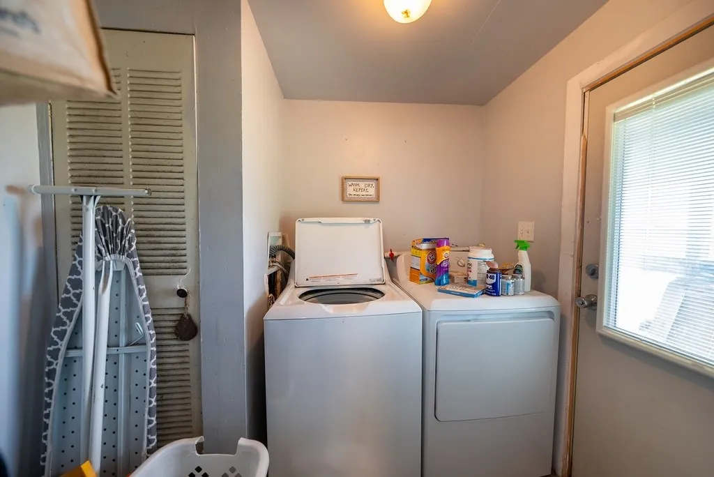 Dedicated laundry area featuring a utility closet, and an exterior access door with integrated blinds