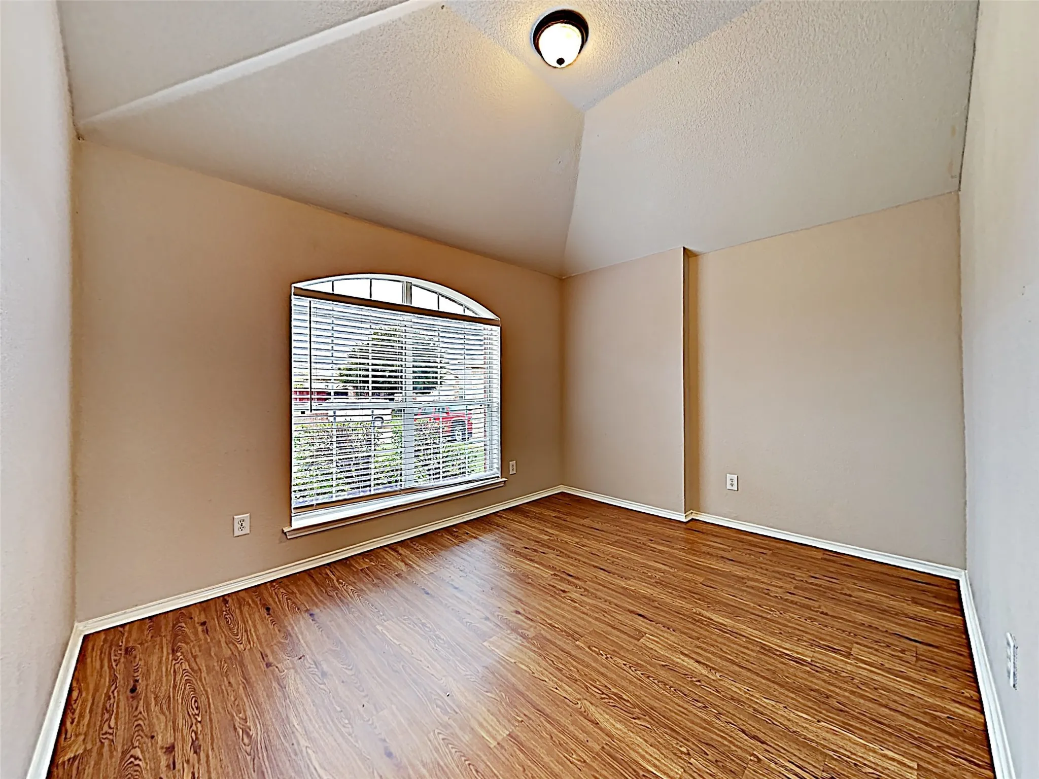 Room featuring a vaulted ceiling and wood-finish​​‌​​​​‌​​‌‌​‌‌​​​‌‌​‌​‌​‌​​​‌​​ flooring