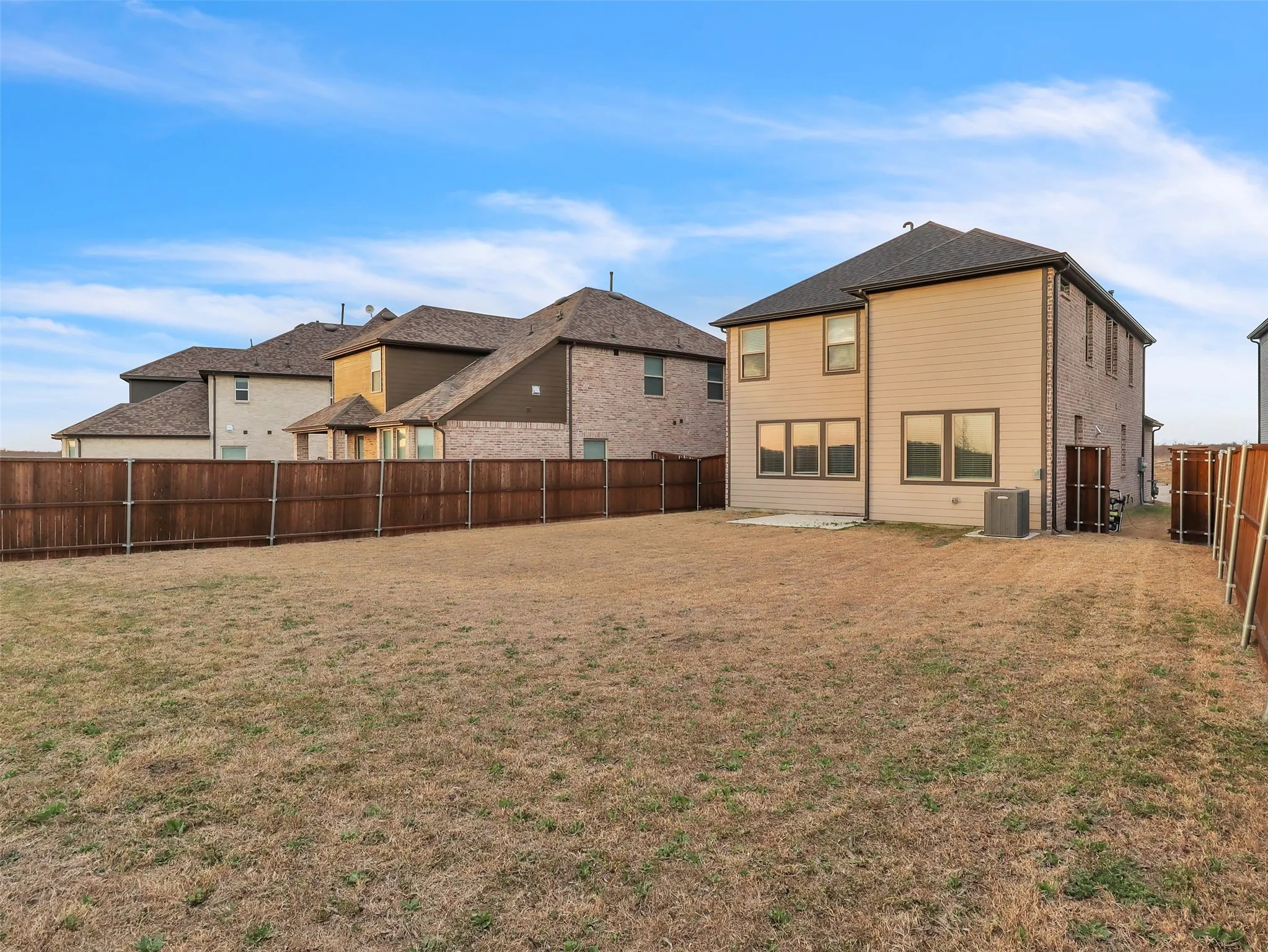 Expansive backyard area with a full privacy fence