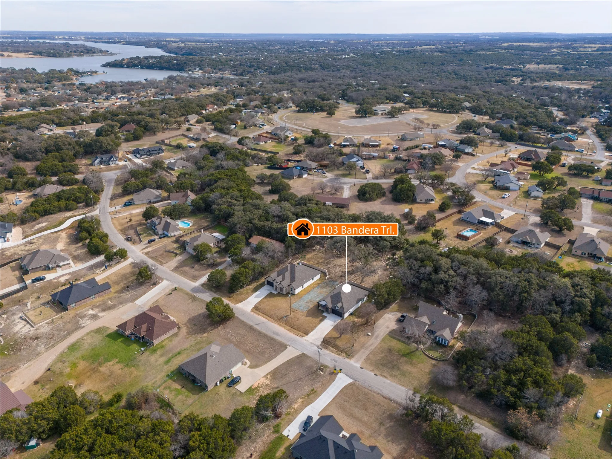 Aerial depiction of a residential neighborhood with a prominent body of water in the background