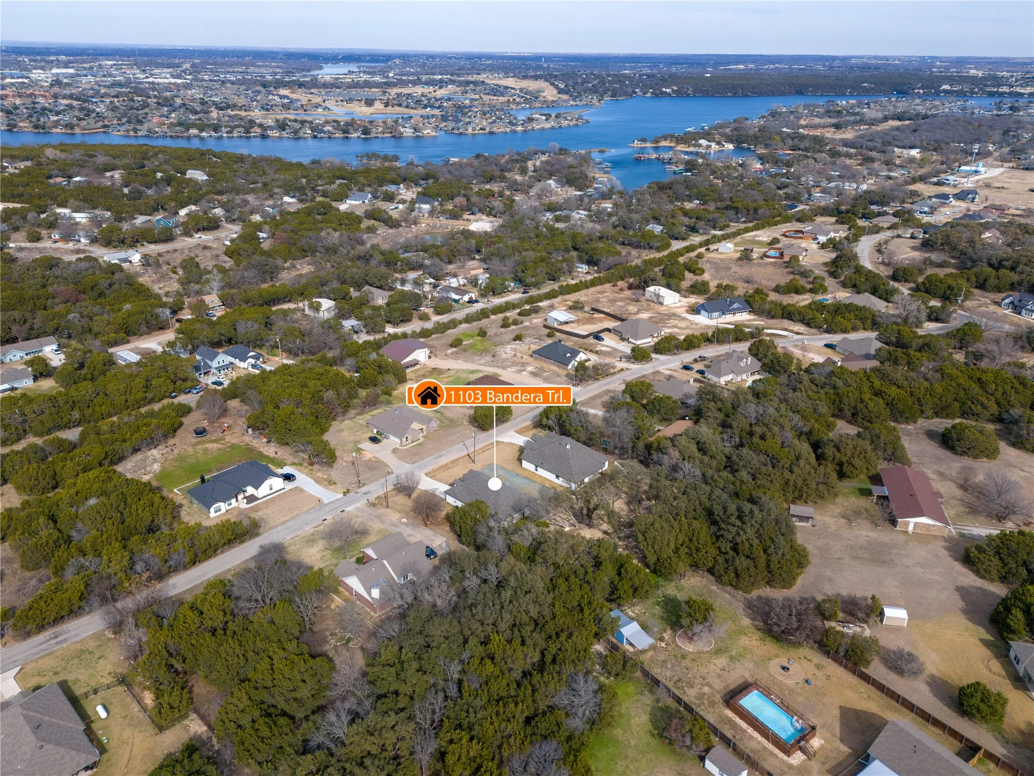 Aerial perspective showcasing a residential area with a prominent body of water in the background