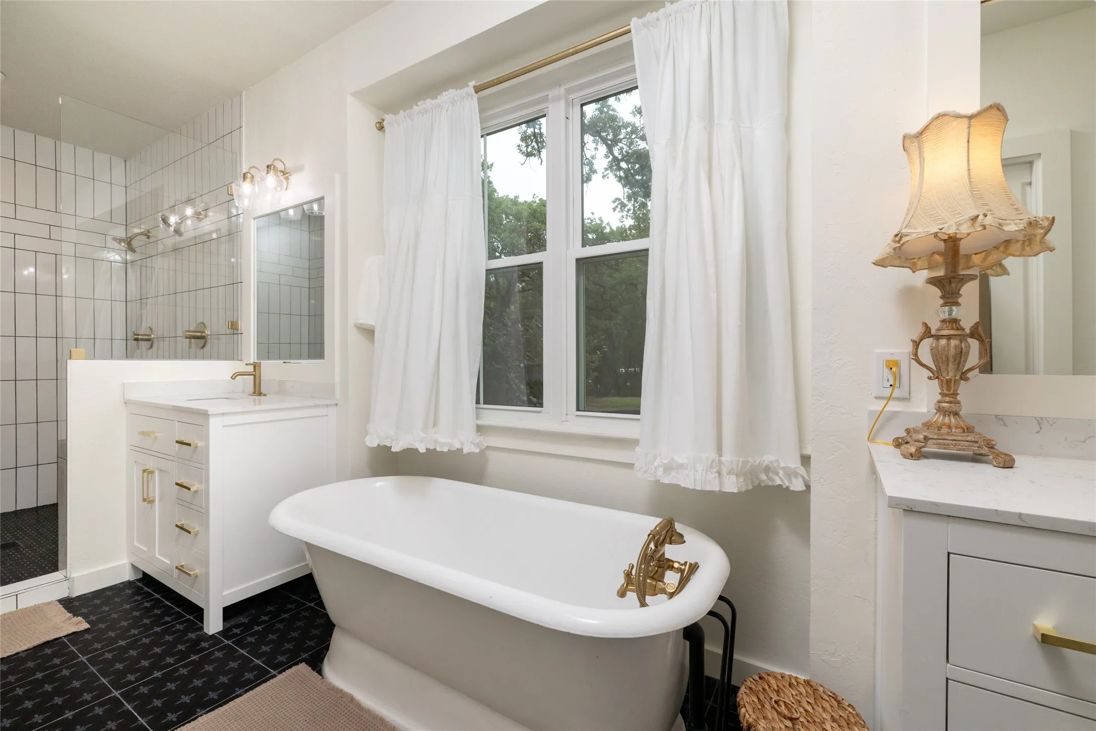 Freestanding soaking tub with gold-tone fixtures
