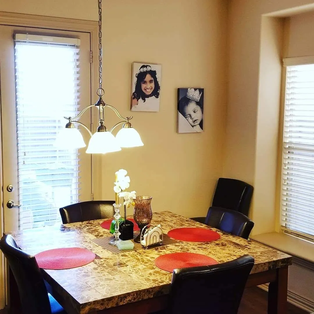 Dining area featuring a tray ceiling with recessed lighting and a bay window with blinds