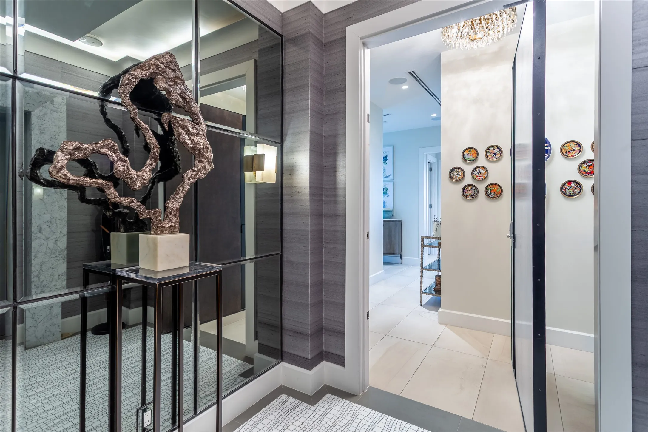 Direct Access Elevator Entry with Carrera marble surround, Thasos mosaic floor, silk wallpaper & pivot door.