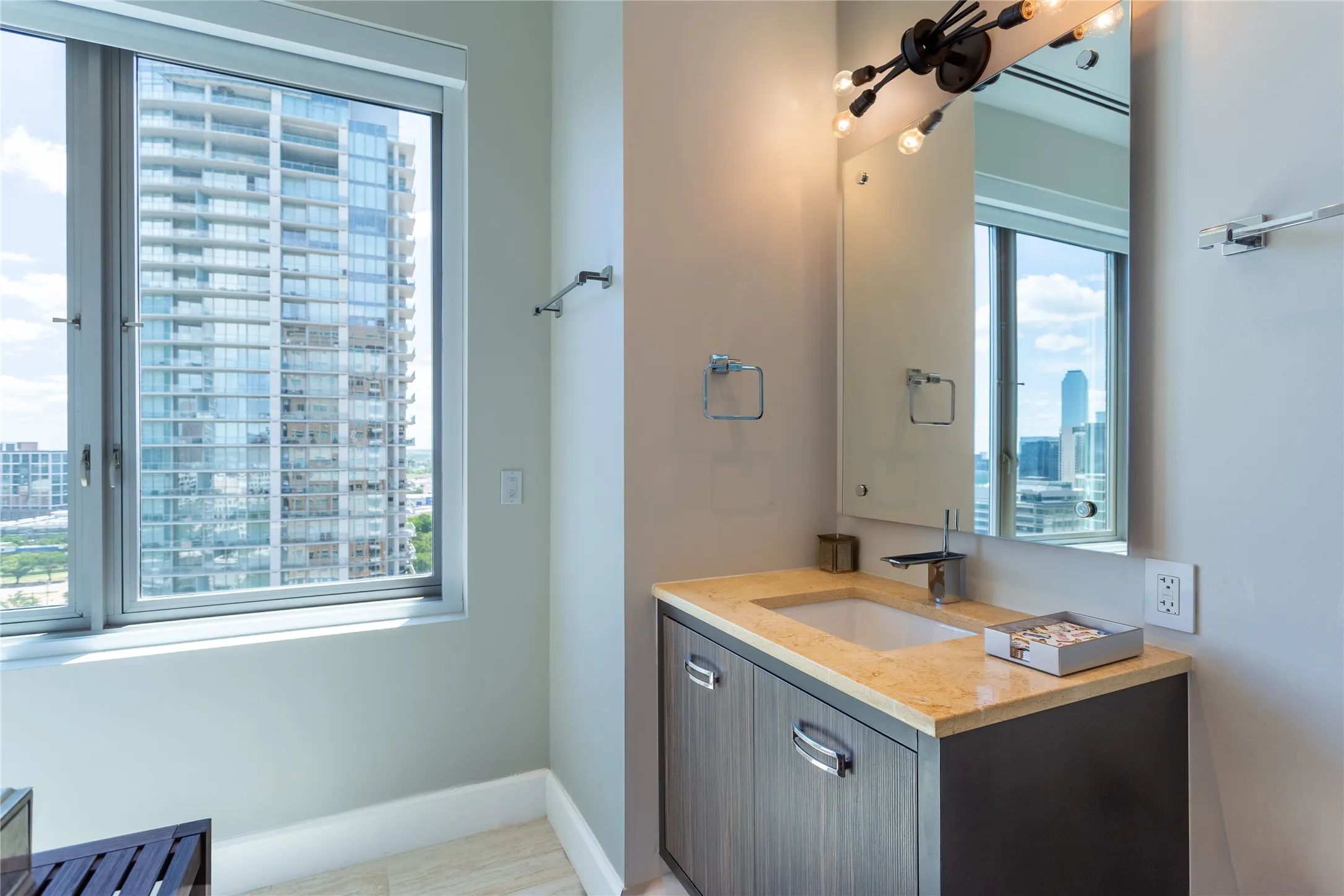 Guest ensuite Bath features custom Bentwood cabinets & Limestone Quart vanity.